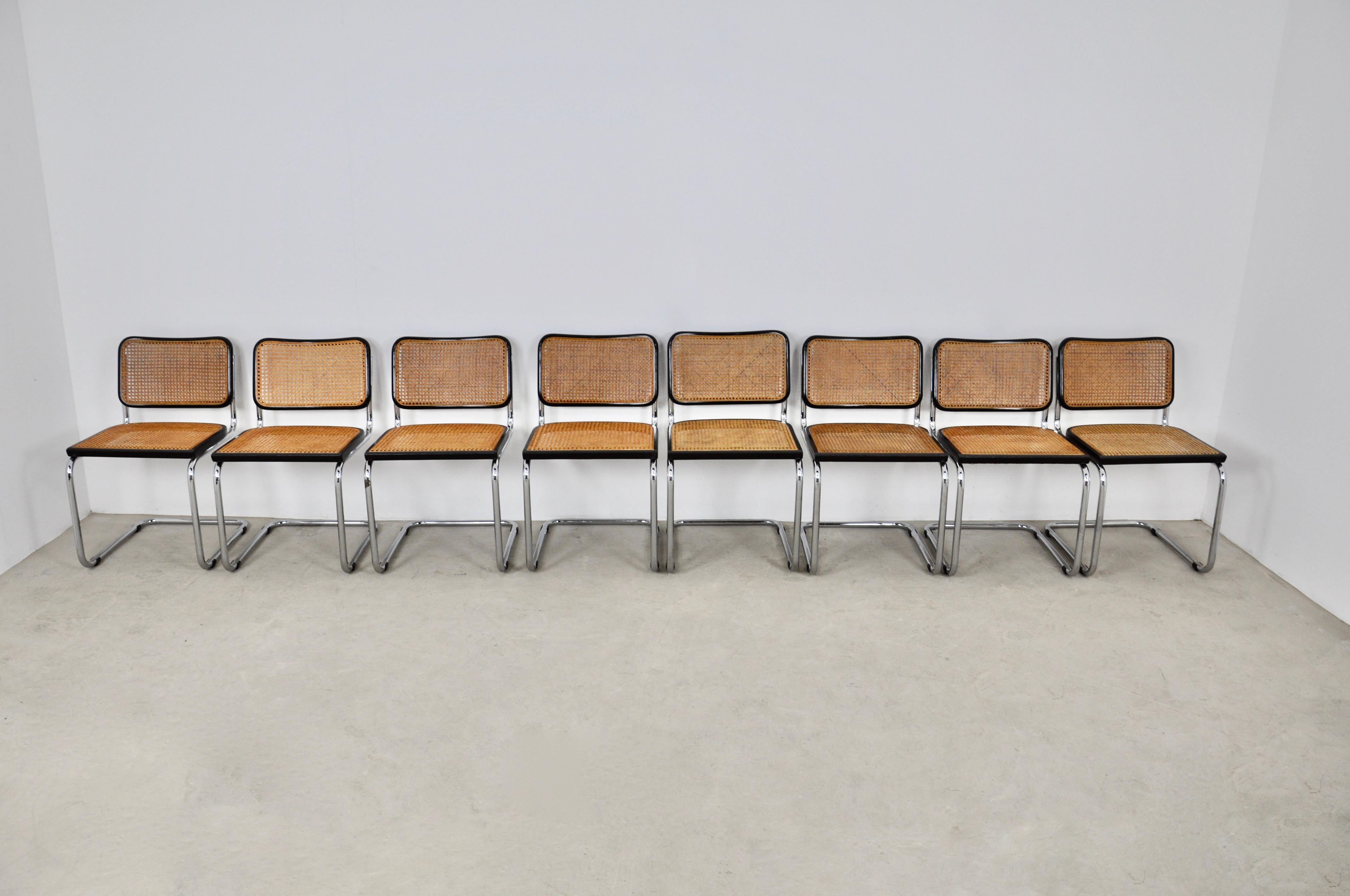 Set of 8 black metal chairs, wooden structure and cane. wear due to time and age of the chairs wear on the metal, seat height 46 cm.