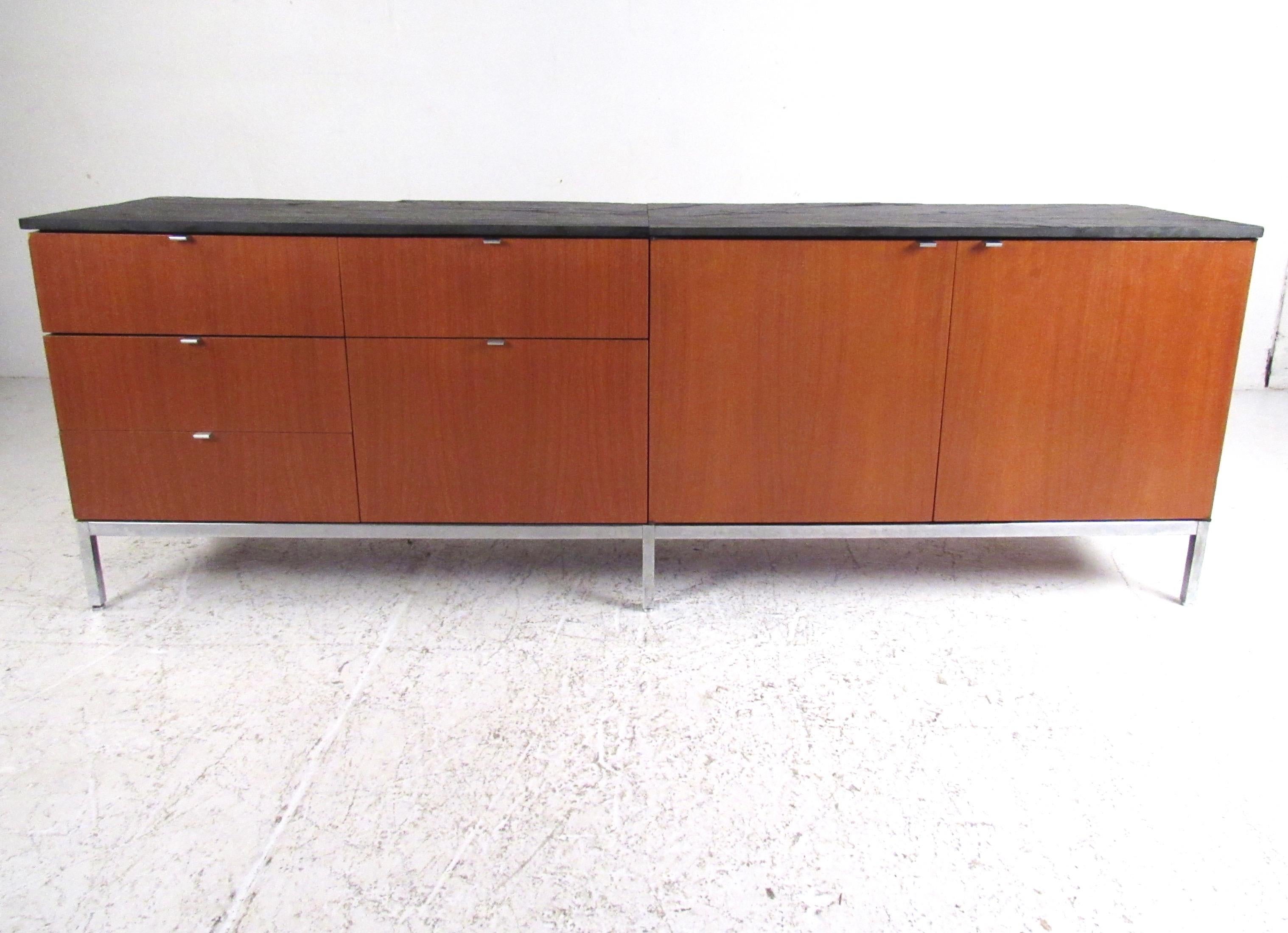 This beautiful Mid-Century Modern sideboard features rich vintage walnut finish, chrome drawer pulls, partially finished back, and stunning slate top design. Ideal office credenza for elegant home or business workspace. Spacious storage options for