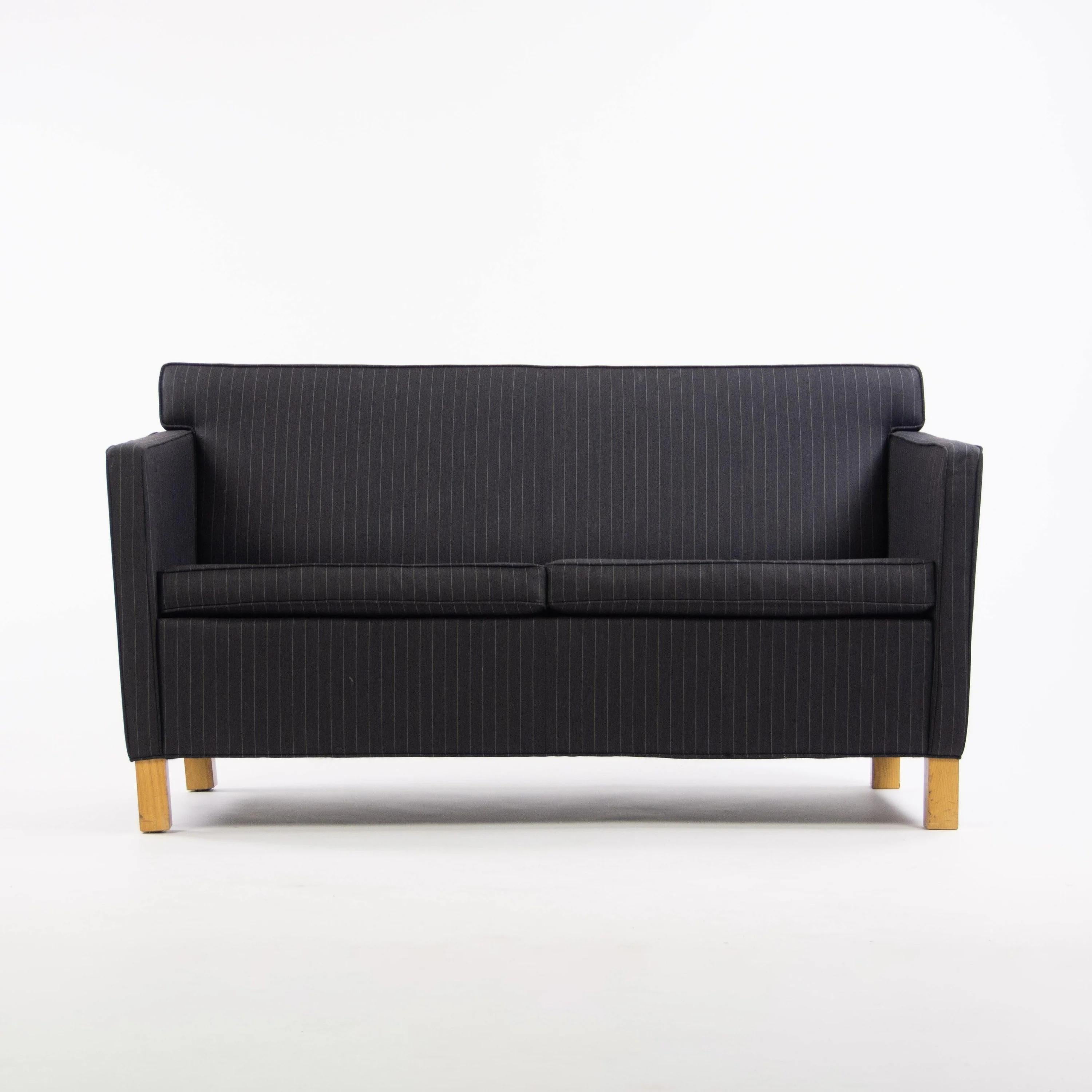 This rare Knoll Krefeld settee has been with us in our storefront gallery since we began fabricating our pieces. This one is a dark navy blue design with pinstripe fabric. Solid volume with Bauhaus personality. This is a different kind of aesthetic