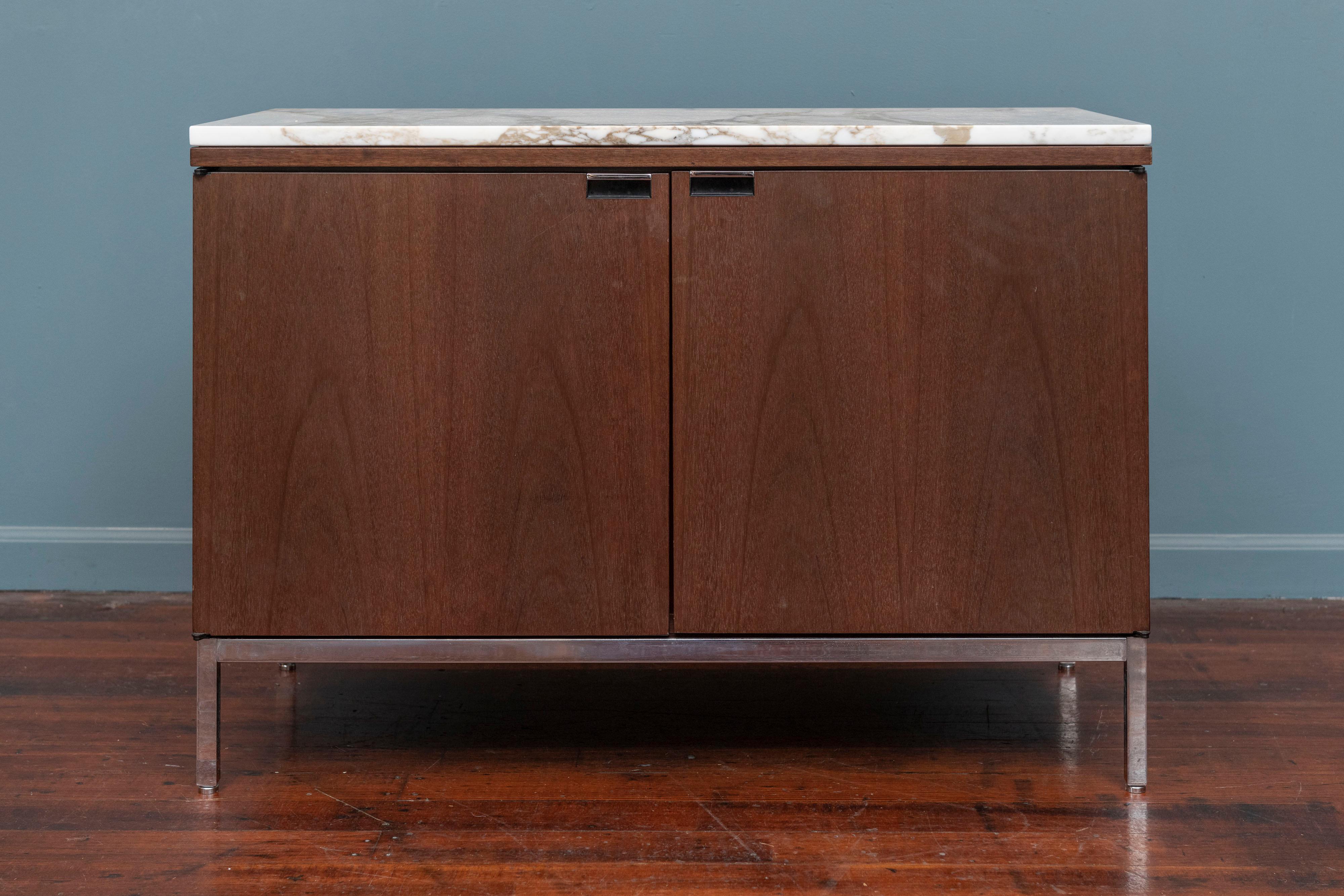 Knoll style marble top walnut two door credenza or cabinet. Having four adjustable shelves and a later added electrical access hole. Supported on a chrome squared frame on adjustable feet.
In very good original condition and ready to install, top