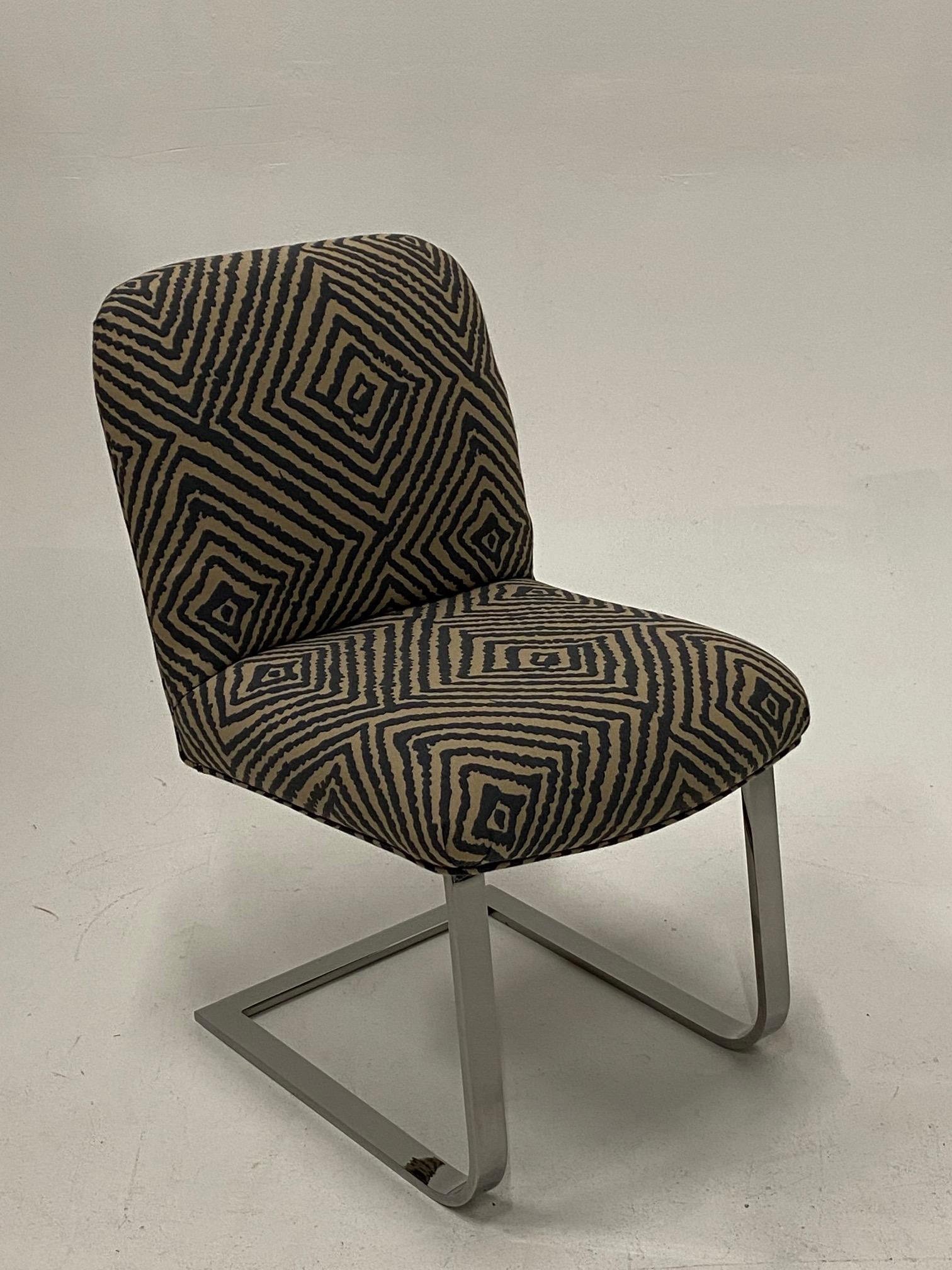 Great looking side or desk chair by Knoll having sleek chrome base and new taupe and black geometric upholstery appropriate to the era of the chair.