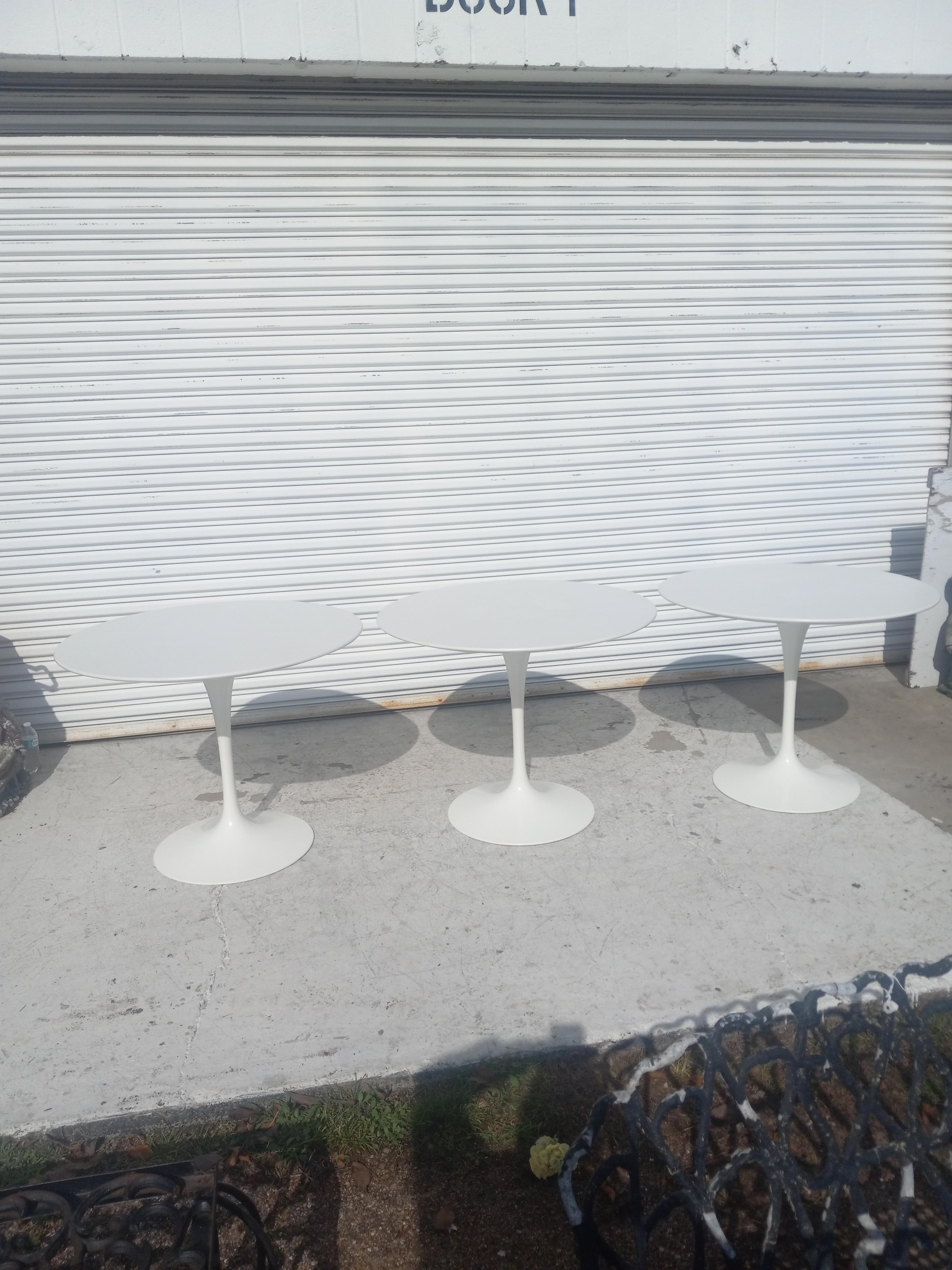 This is a Pedestal Dining Table, originally designed in 1956 by Eero Saarinen for Knoll. This particular piece was produced in the USA in the 1960s. The base is formed of cast iron which is coated in a white satin finish. Its top is made of smooth