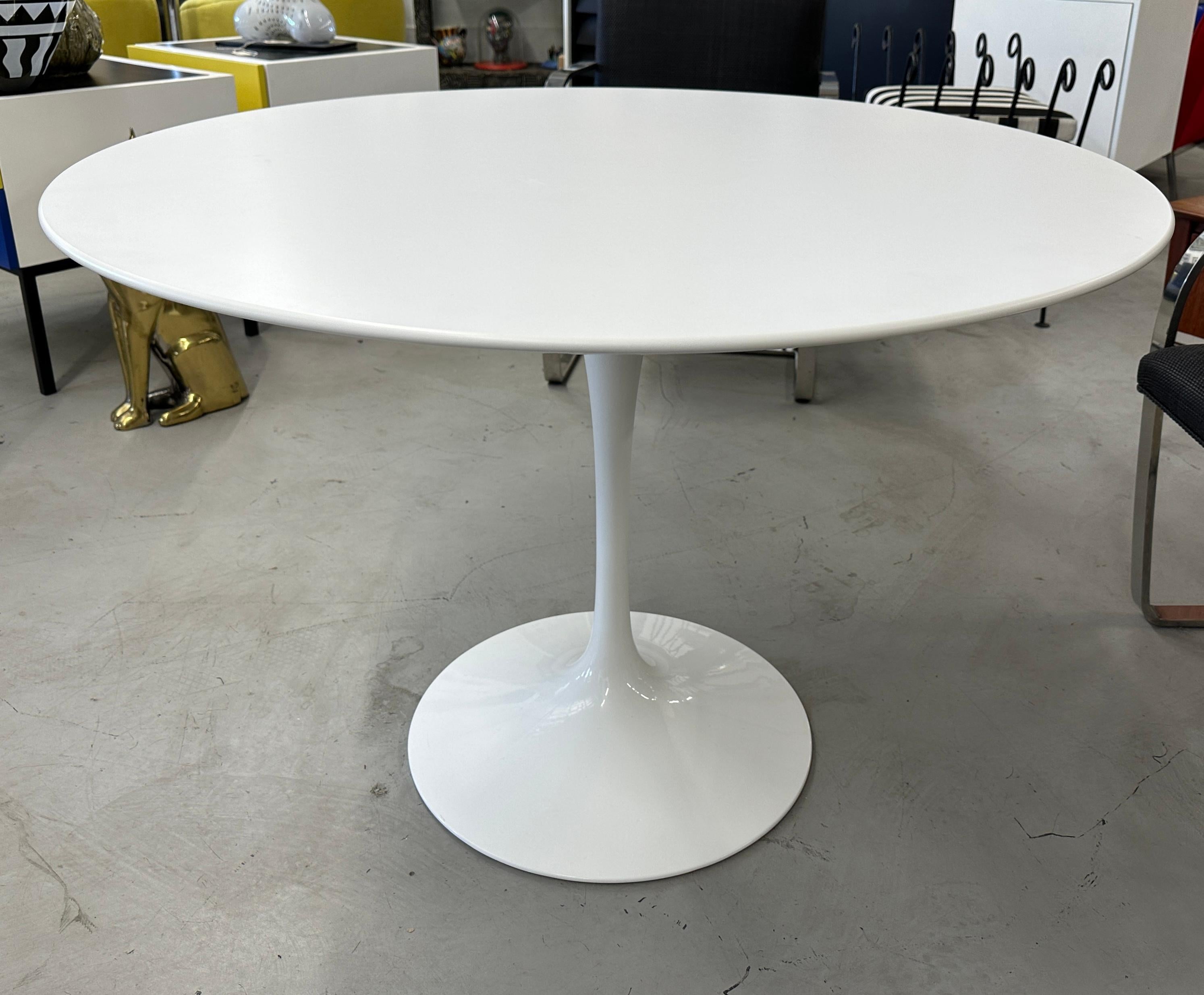 A Knoll white laminate pedestal table designed by Eero Saarinen. An iconic design this table is of recent manufacture circa 2010 or so. The table is in good condition with some minor marks from handling. It is pictured in our gallery with 4 Mies Van