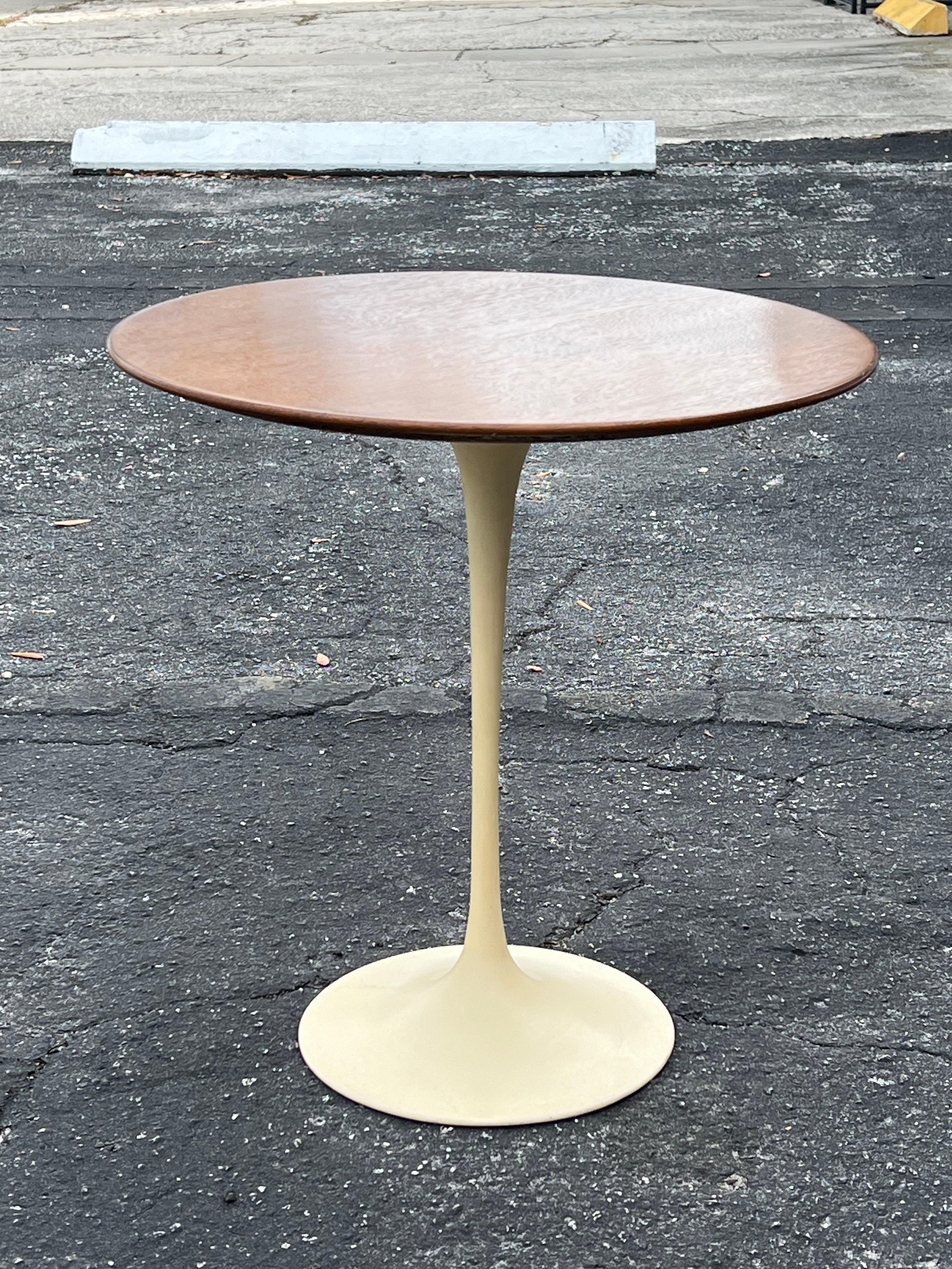 A Classic Eero Saarinen for Knoll occasional table with walnut top. Excellent original condition, base has a cream color, original tag intact.
