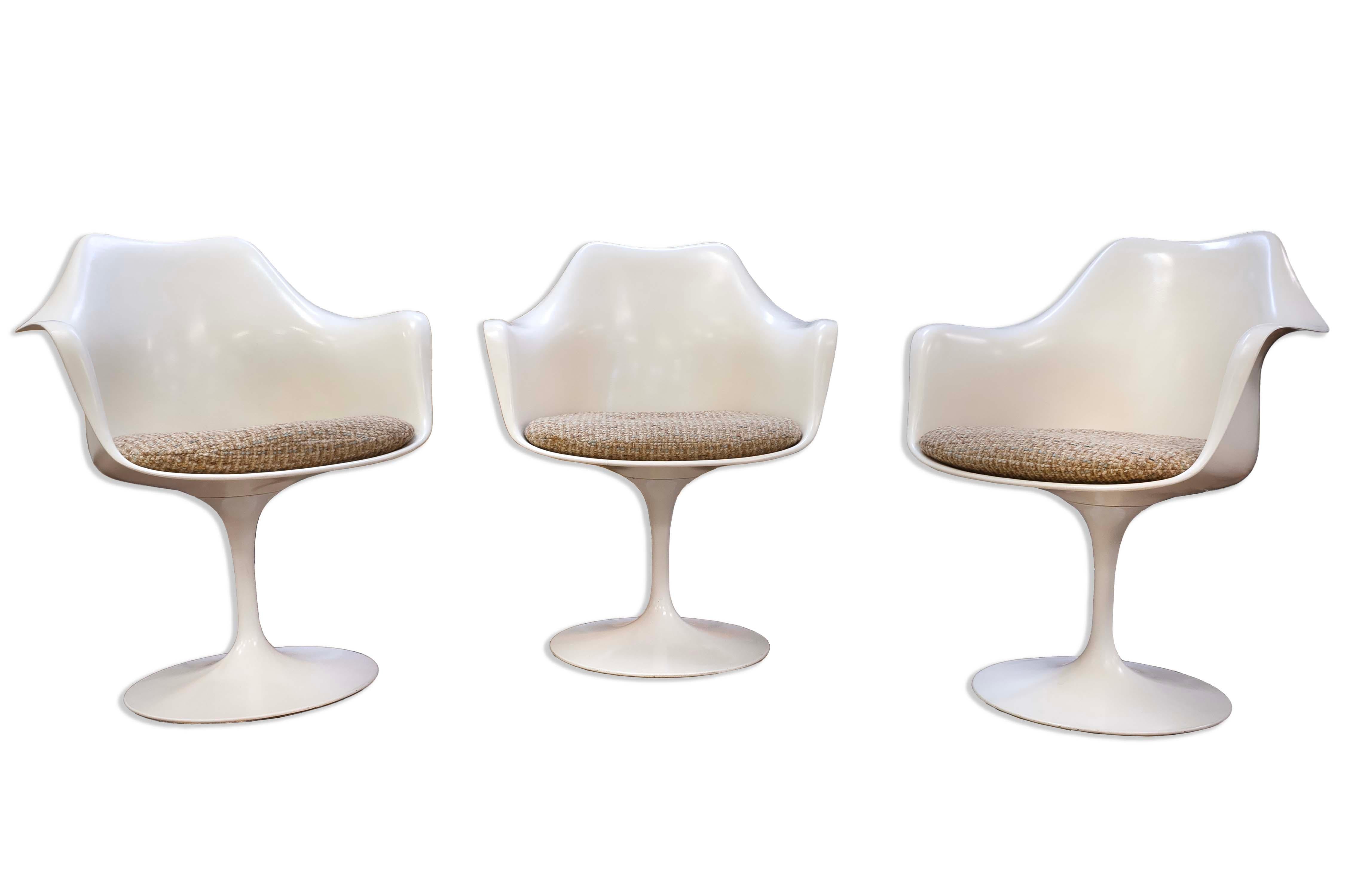 Enhance your living space with this exquisite set of three Mid-Century Modern Saarinen Tulip Arm Chairs by Knoll. These iconic chairs feature a fluid, sculptural form that beautifully complements any modern interior with their timeless elegance and