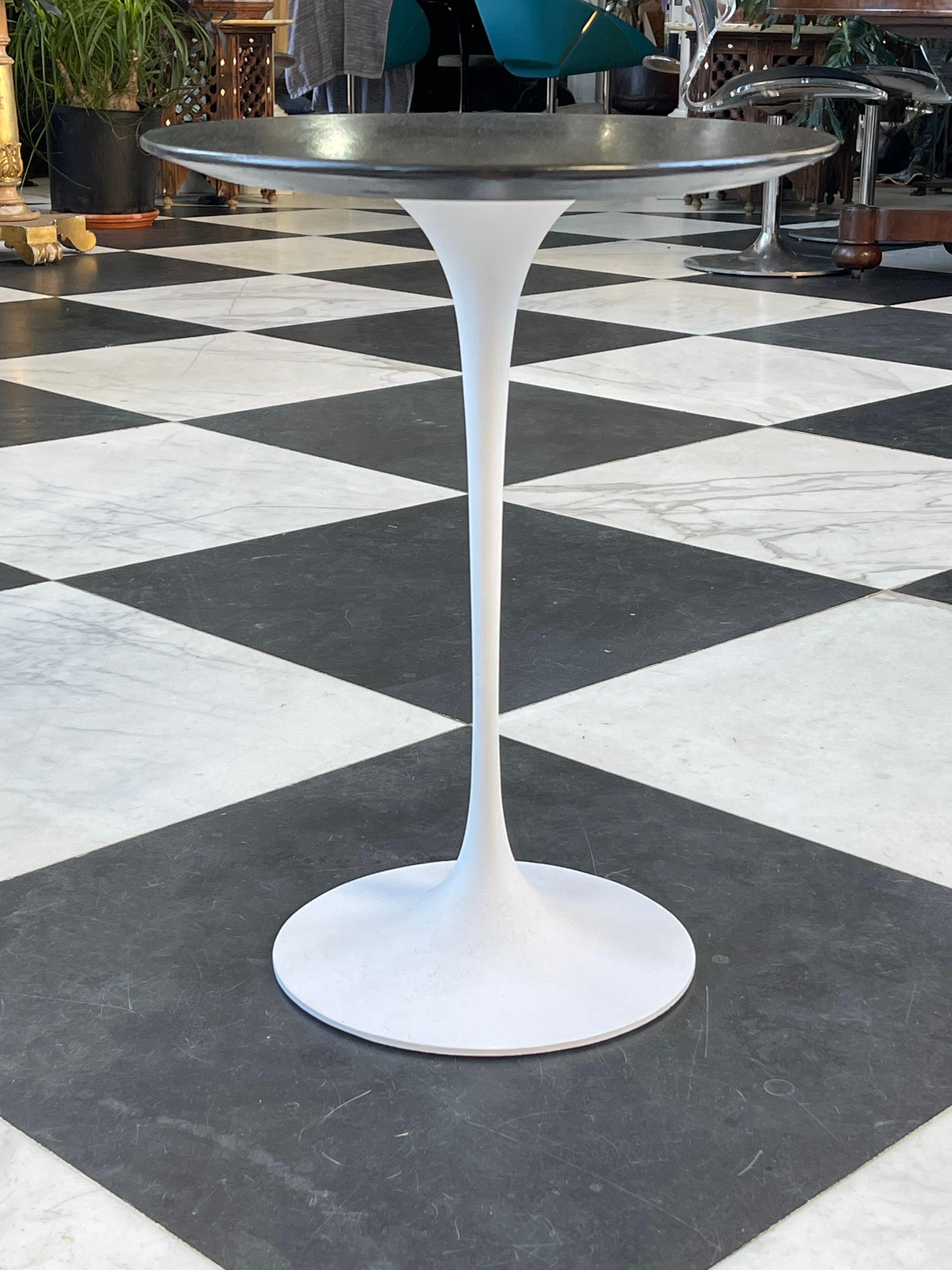 A Mid-Century Modern Eero Saarinen for Knoll Tulip side table. 
It retains the early Knoll label.
The base has been repainted the top is a charcoal black. 
 
