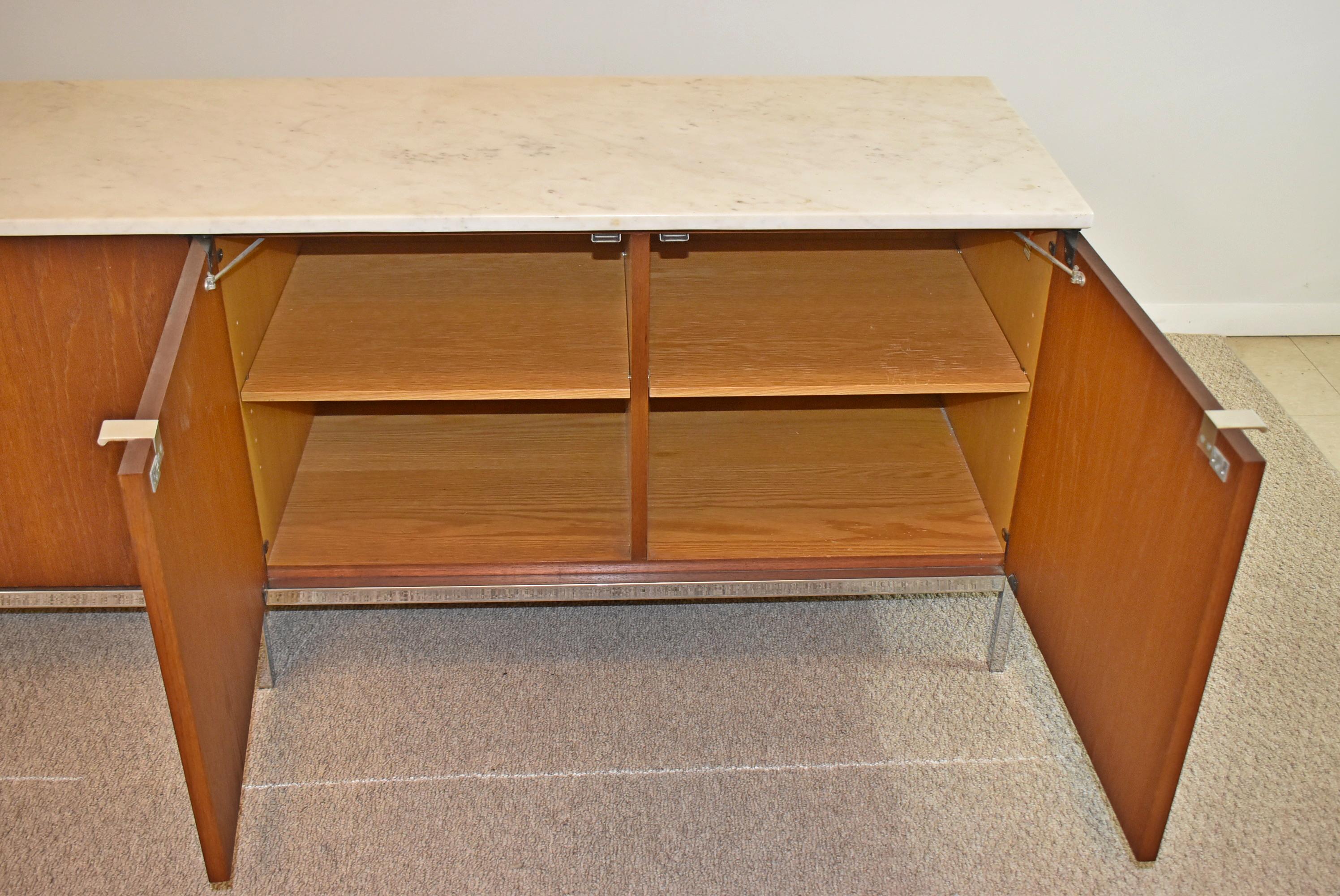 Knoll Walnut credenza with marble top. Circa 20th century around 1952. Walnut 4 door credenza on a square tube chrome frame with adjustable shelves and a white and grey marble top. Great condition, consistent with wear due to age and usage. Knoll