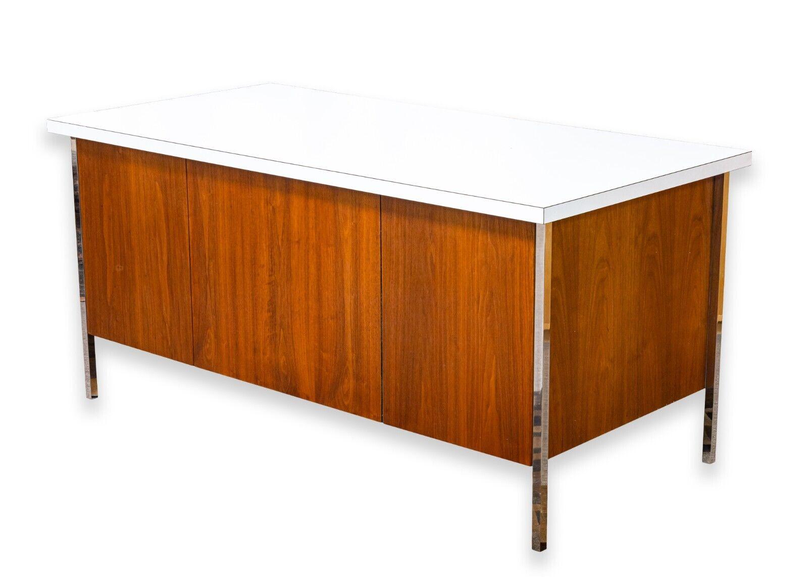 A Knoll walnut double pedestal desk. This is a gorgeous office desk, perfect for a mid century home or office. It features a classic, simple design, and a choice set of materials. This desk is constructed with a gorgeous walnut wood with beautiful