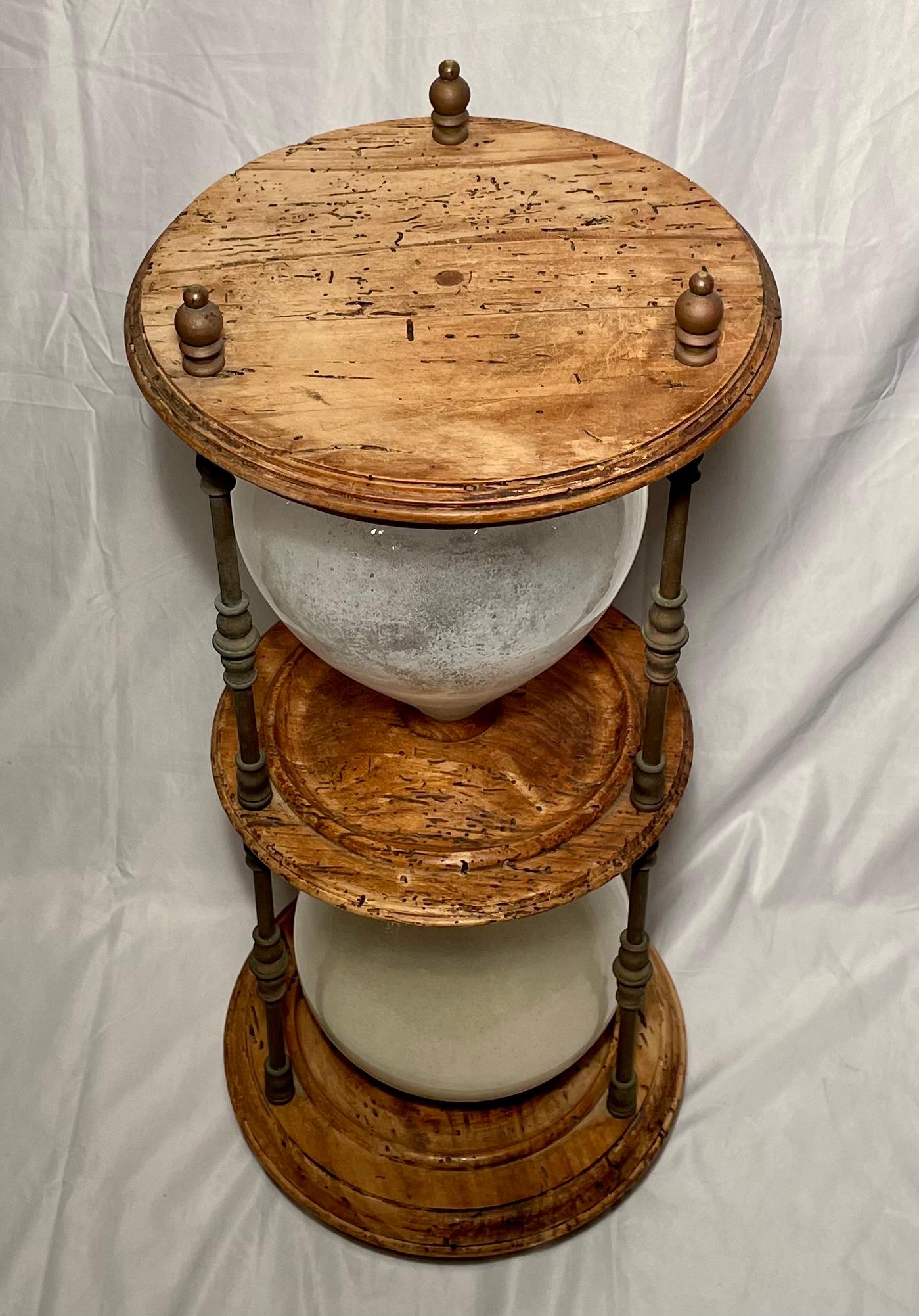 Knotted wood figural hourglass occasional table.