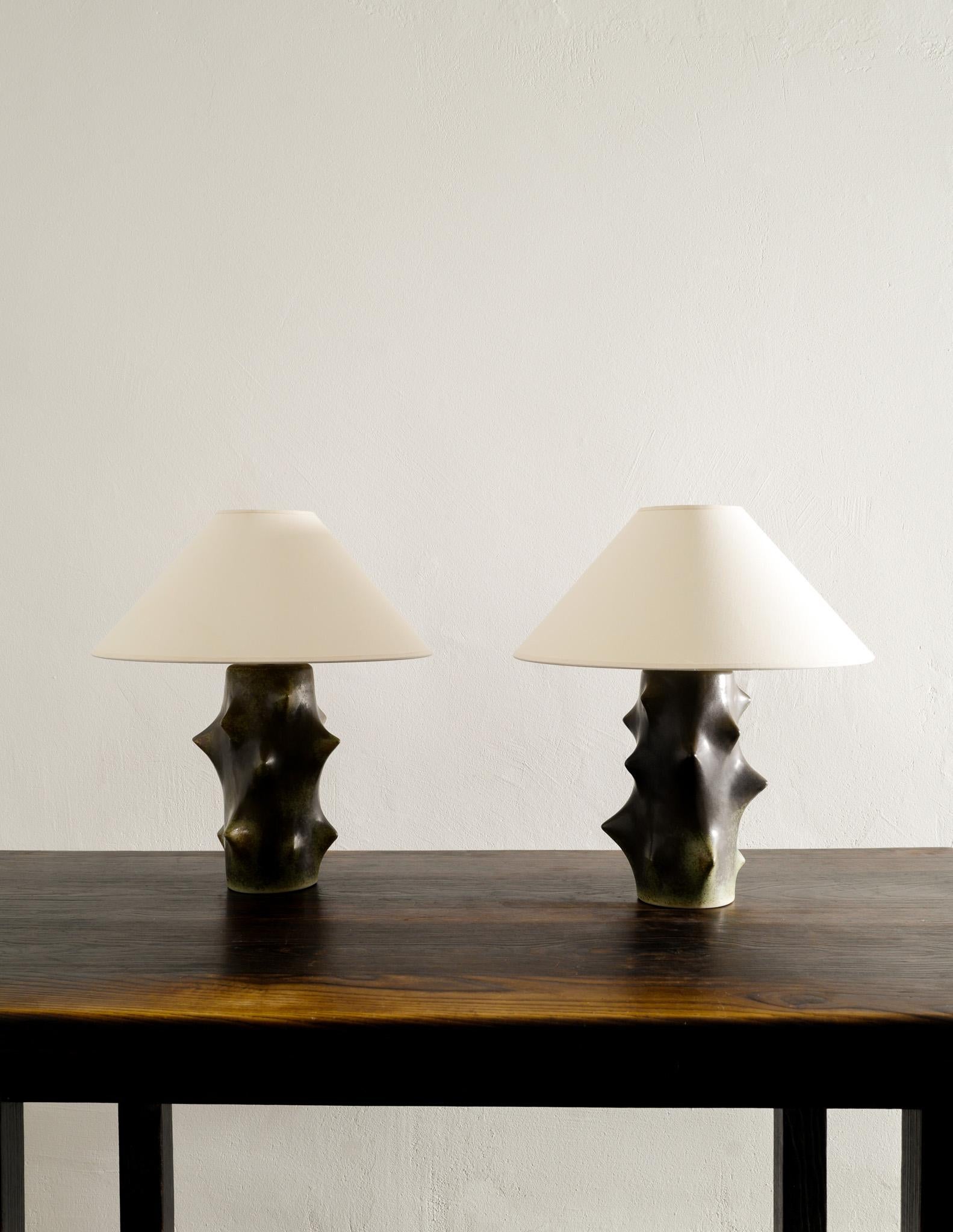 Iconic and rare pair of mid century ceramic table / bed lamps by Knud Basse and Produced by Michael Andersen, Denmark in the 1970s. In great vintage condition with minimal signs of use. Both lamps are working and can be US wired upon request.