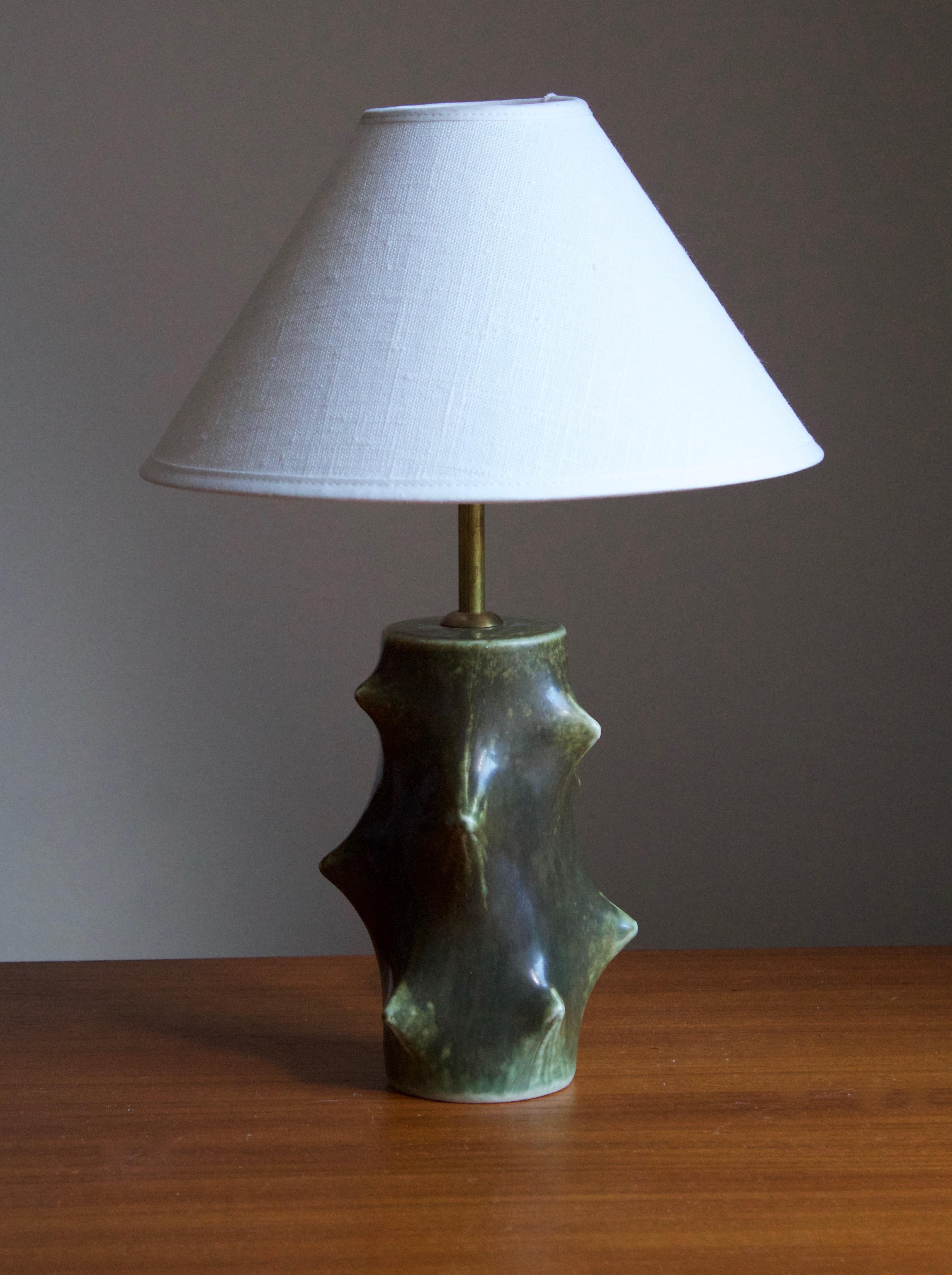 A small organic table / desk lamp designed by Danish ceramicist Knud Basse, produced by Michael Andersen, Denmark in partnership danish lamp manufacturer Lyfa. 

Stated dimensions exclude lampshade, height include socket. Sold without