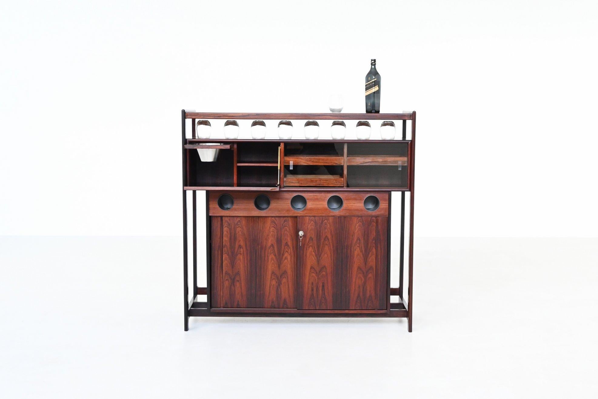 Beautiful dry bar designed by Knud Bent for Dyrlund, Denmark 1960. This sculptural and highly functional dry bar, designed by Knud Bent for Dyrlund in the 1960s, is a refined example of Danish craftsmanship at its finest. Constructed in richly