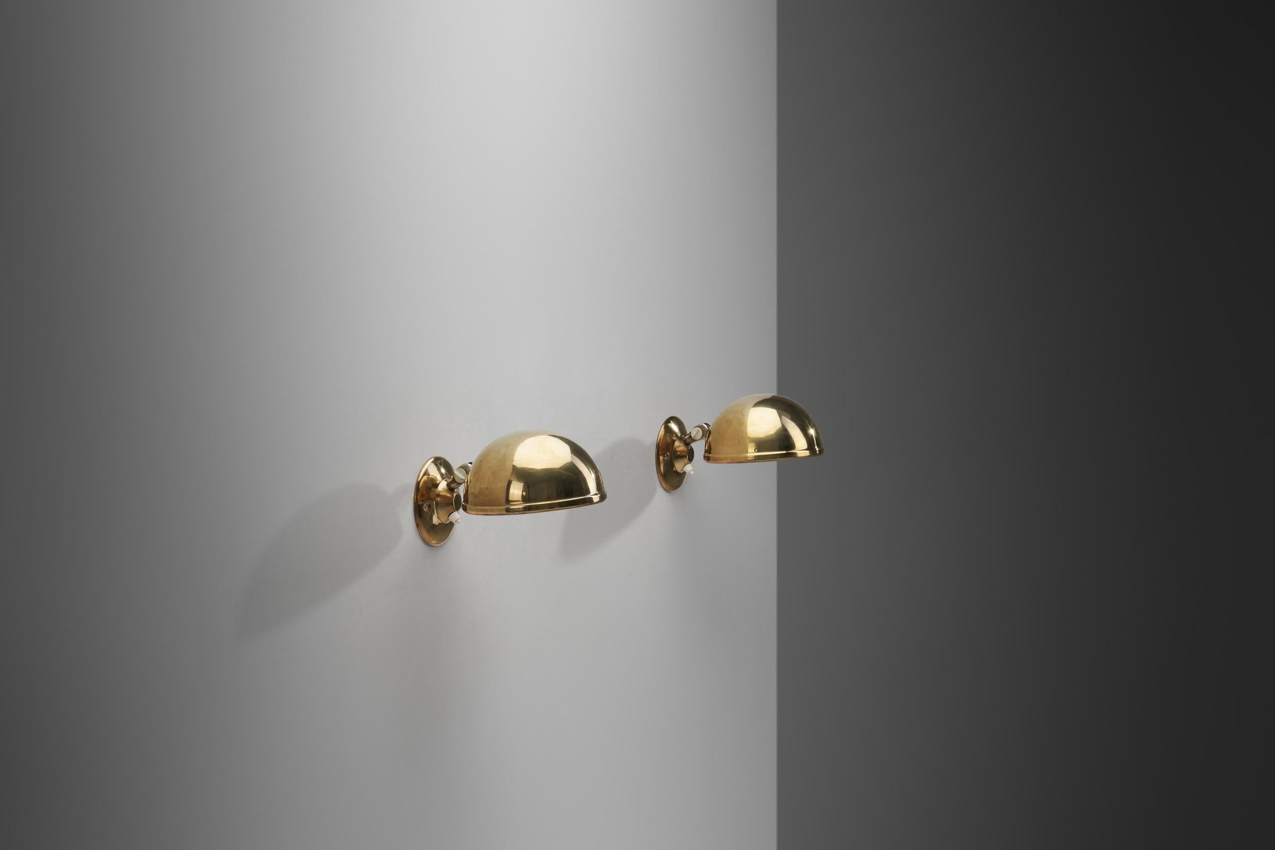 This pair of wall lamps was designed by Knud Christensen in Denmark during the 1970s, an era in which Denmark saw the birth of many of its most iconic lighting models. It was a period of consistency, excellence and sophistication design wise.

The