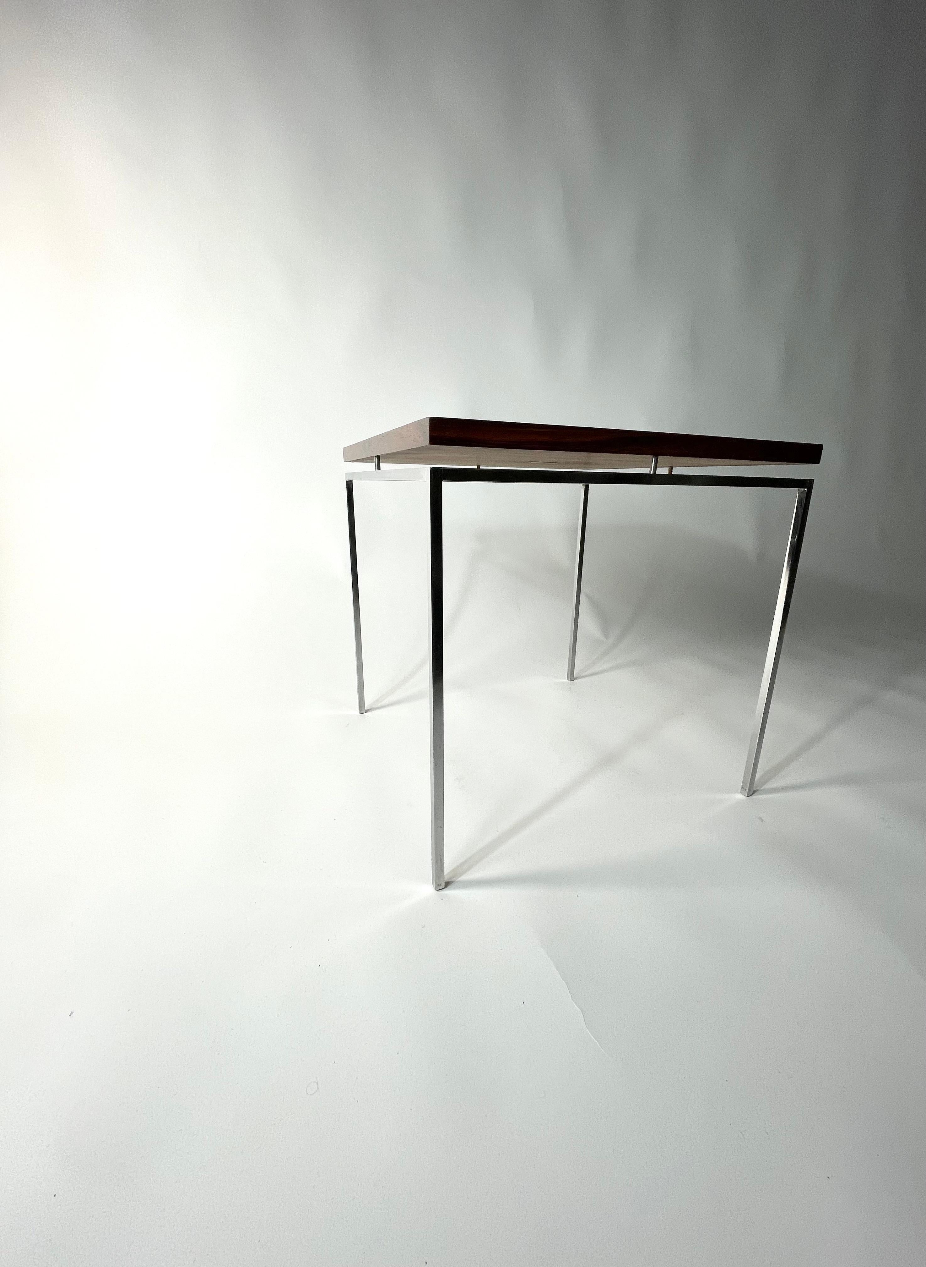 Knud Joos Rosewood Side Table with beautiful steel frame. 

 Dimensions: 16.5 L x 16.5 W  x 16.25H 

About the Designer:

Knud Joos was a Danish furniture designer and craftsman known for his contributions to mid-century modern design. He was born