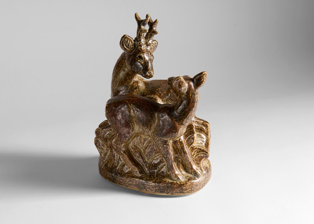 This naturalistic and dynamic scene of a deer and doe was designed by Knud Kyhn who worked for Royal Copenhagen for much of his career. 

Numbered 21449, incised KK.