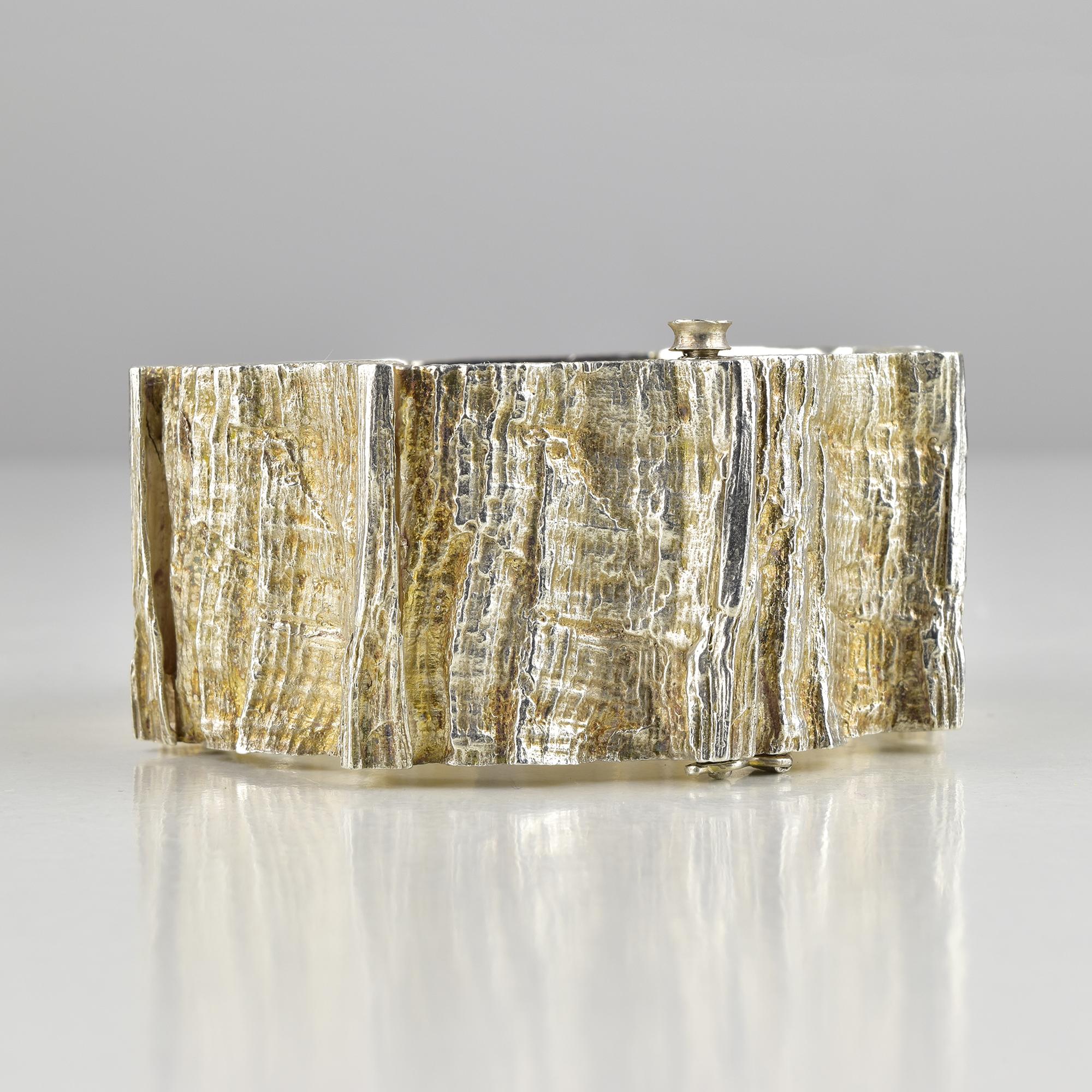 A striking mid-century Danish sterling silver bracelet designed by Knud V. Andersen for Anton Michelsen, dating to the 1960s. This collectible piece showcases Andersen’s signature “tree bark” texture, expertly rendered in solid sterling silver. The