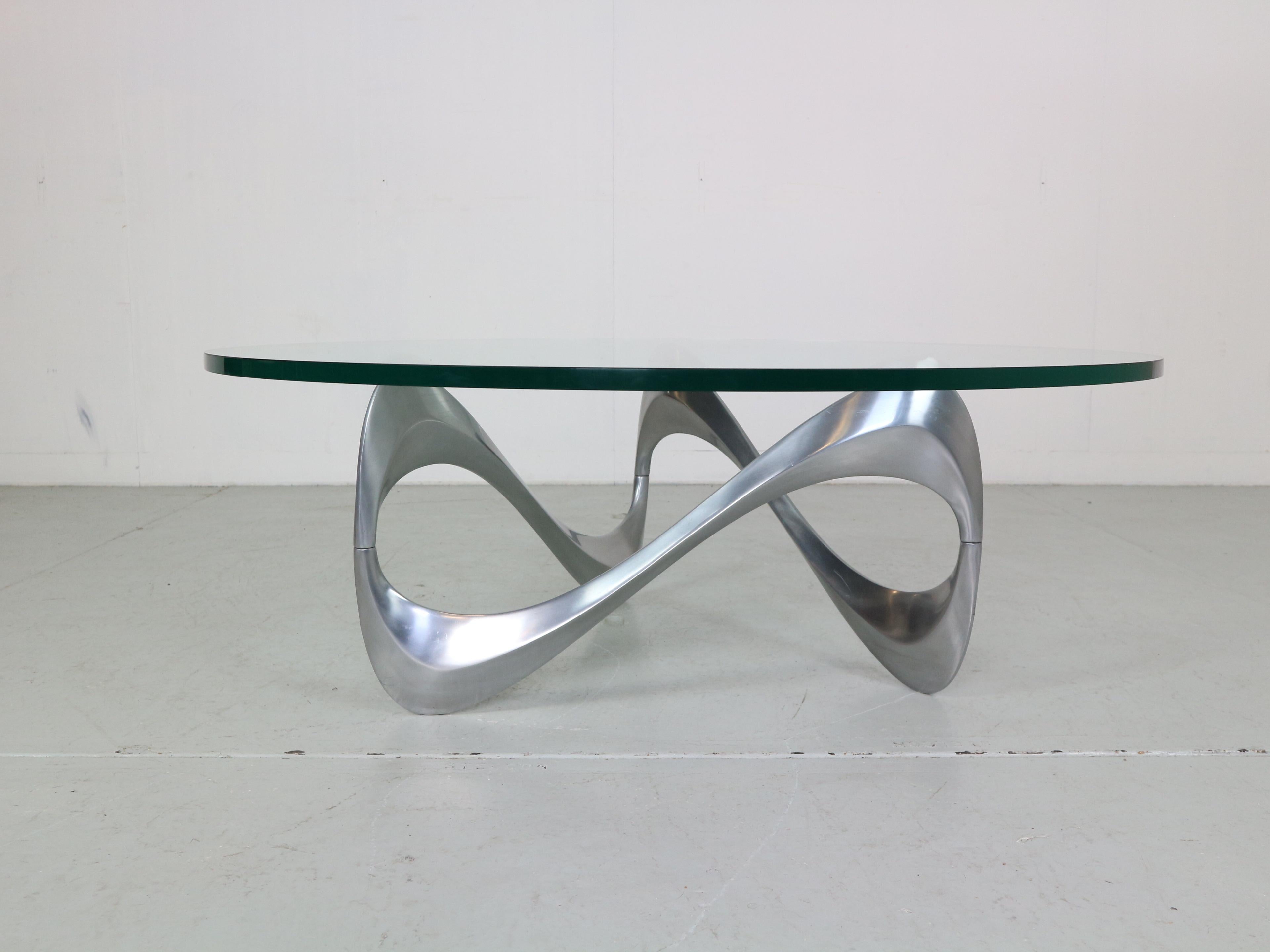 Mid- Century modern period an iconic “Snake” coffee table, designed by Knut Hesterberg and manufactured by Ronald Schimdt in Germany around 1960. 

This eye-catching table has an aluminium base, in eye-catching waved shape which it owes it’s name