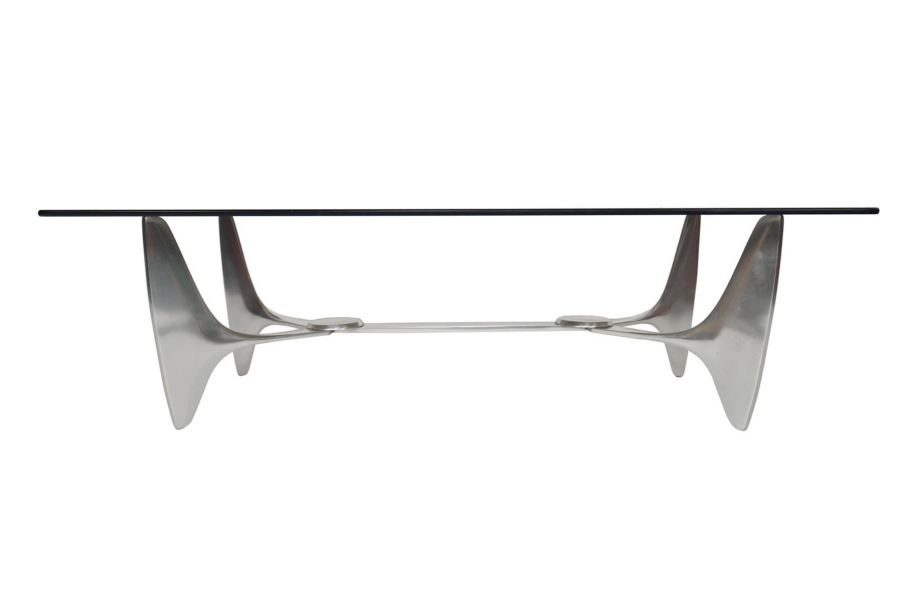 This modern industrial coffee table was designed by Knut Hesterberg for Ronald Schmitt in the 1960s. The aluminum “propeller” frame holds the original sheet of smoked glass. In original condition.

 