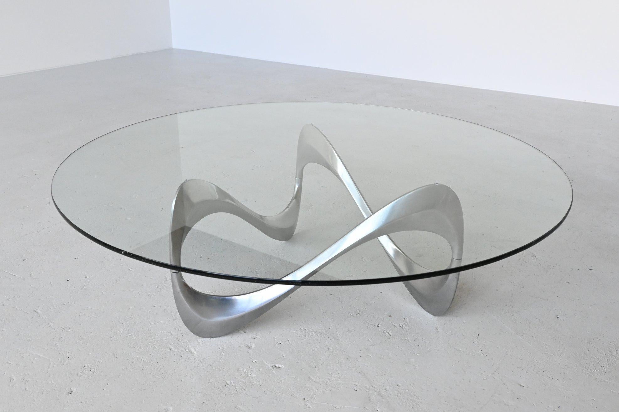 Very nice sculptural snake coffee table designed by Knut Hesterberg and manufactured by Ronald Schmitt, Germany, 1965. This stunning coffee table has an organic shaped polished aluminium base that supports a thick hardened glass top. The shape of