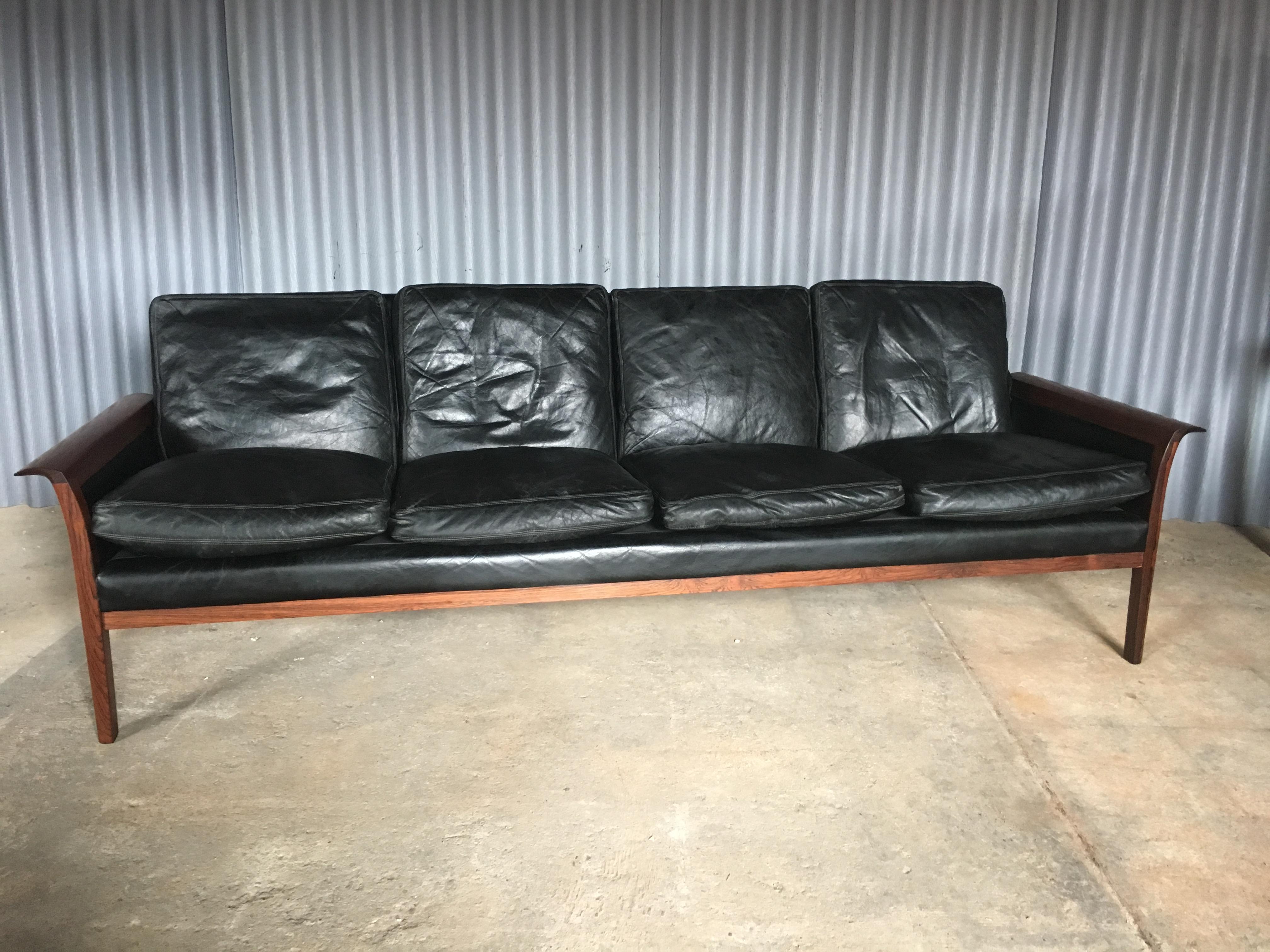 Handsome and rich 4 seater sofa by Designer Knut Saeter for Vatne Mobler of Norway.
Rosewood in excellent condition.
Leather has no rips or tears. Normal age wear as normal.
Measures: H 28.50 in. x W 88 in. x D 30 in.

 