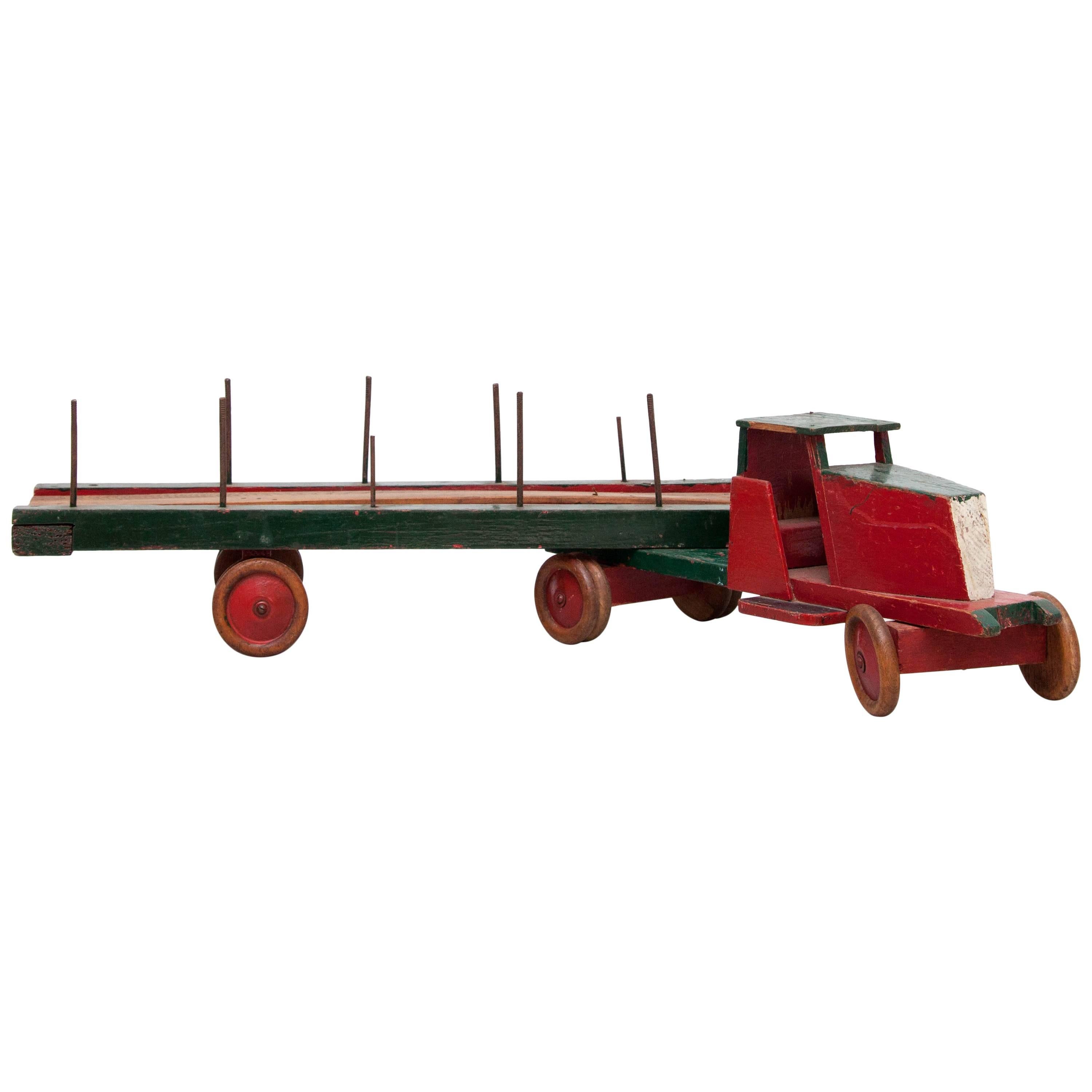 Toy designed by Ko Verzuu, circa 1940.
Manufactured by ADO in Netherlands.

Truck & trailer of wood 
