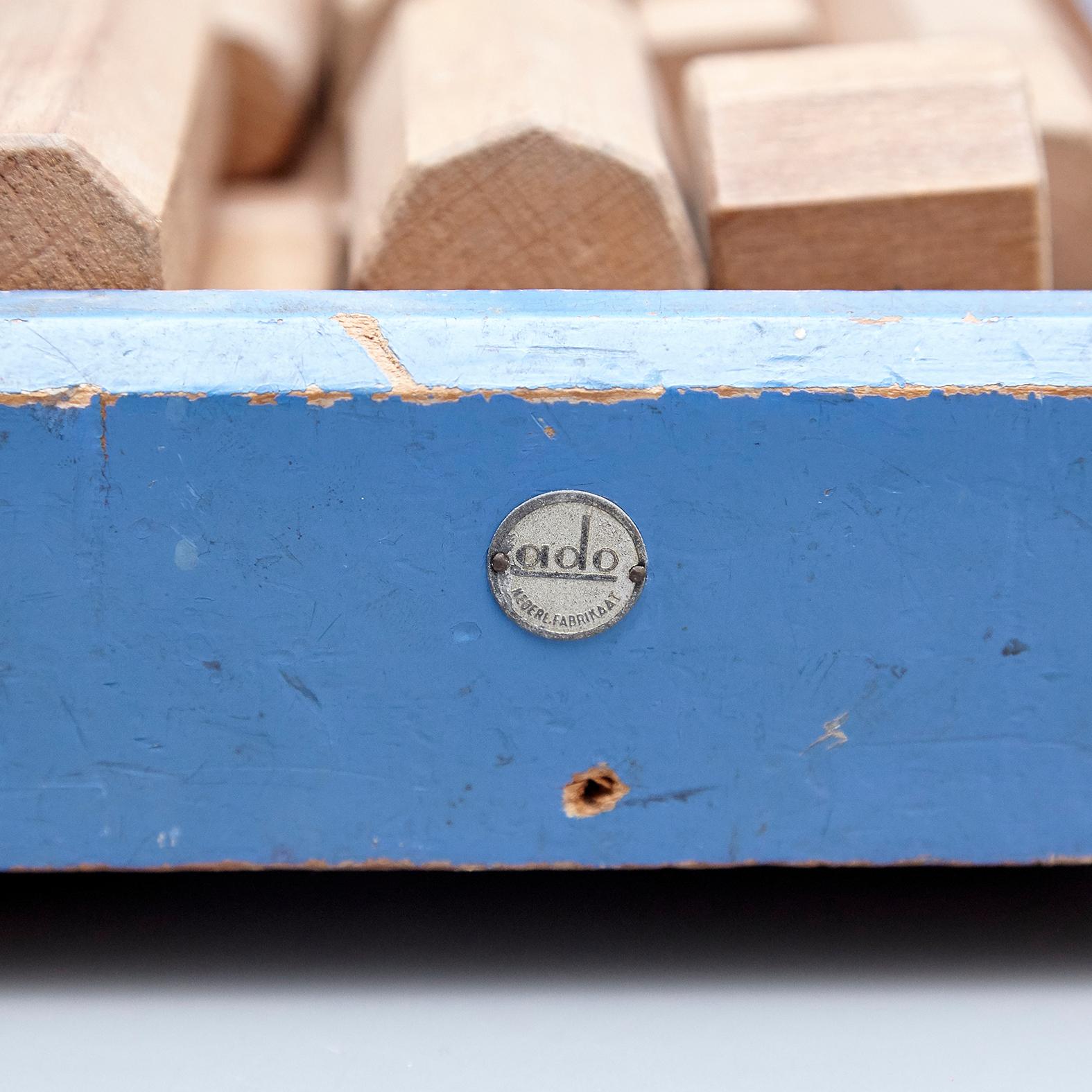 Toy designed by Ko Verzuu, circa 1950.
Manufactured by ADO in Netherlands.

Blue trailer with wooden wheel and set of blocks.

Signed with an ADO metal plate.

In good original condition, with minor wear consistent with age and use,