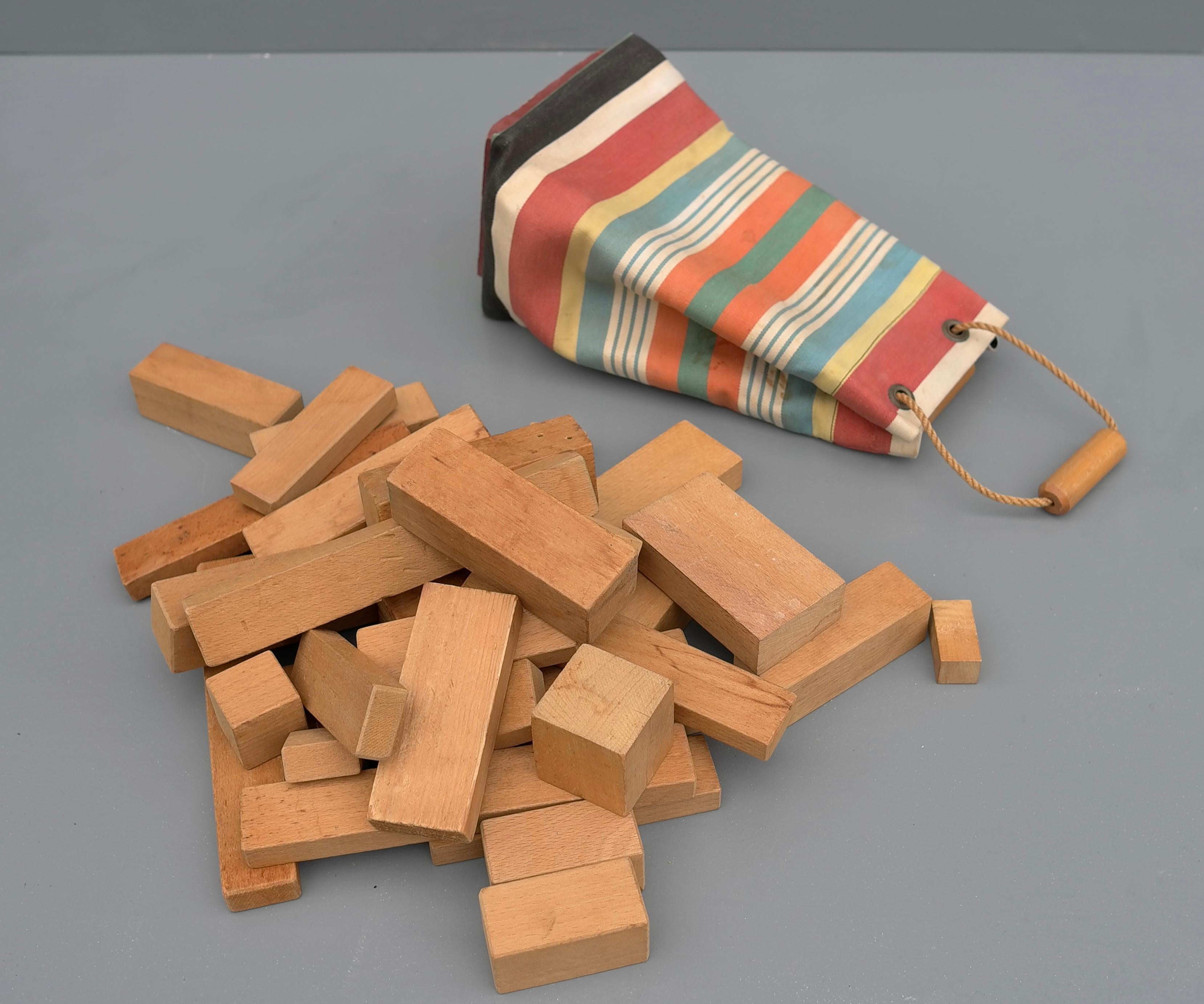 Ko Verzuu mid-century children toy blocks, the Netherlands, 1950's

Lovely patinated wooden blocks in different shapes and sizes with a colorful striped canvas bag.