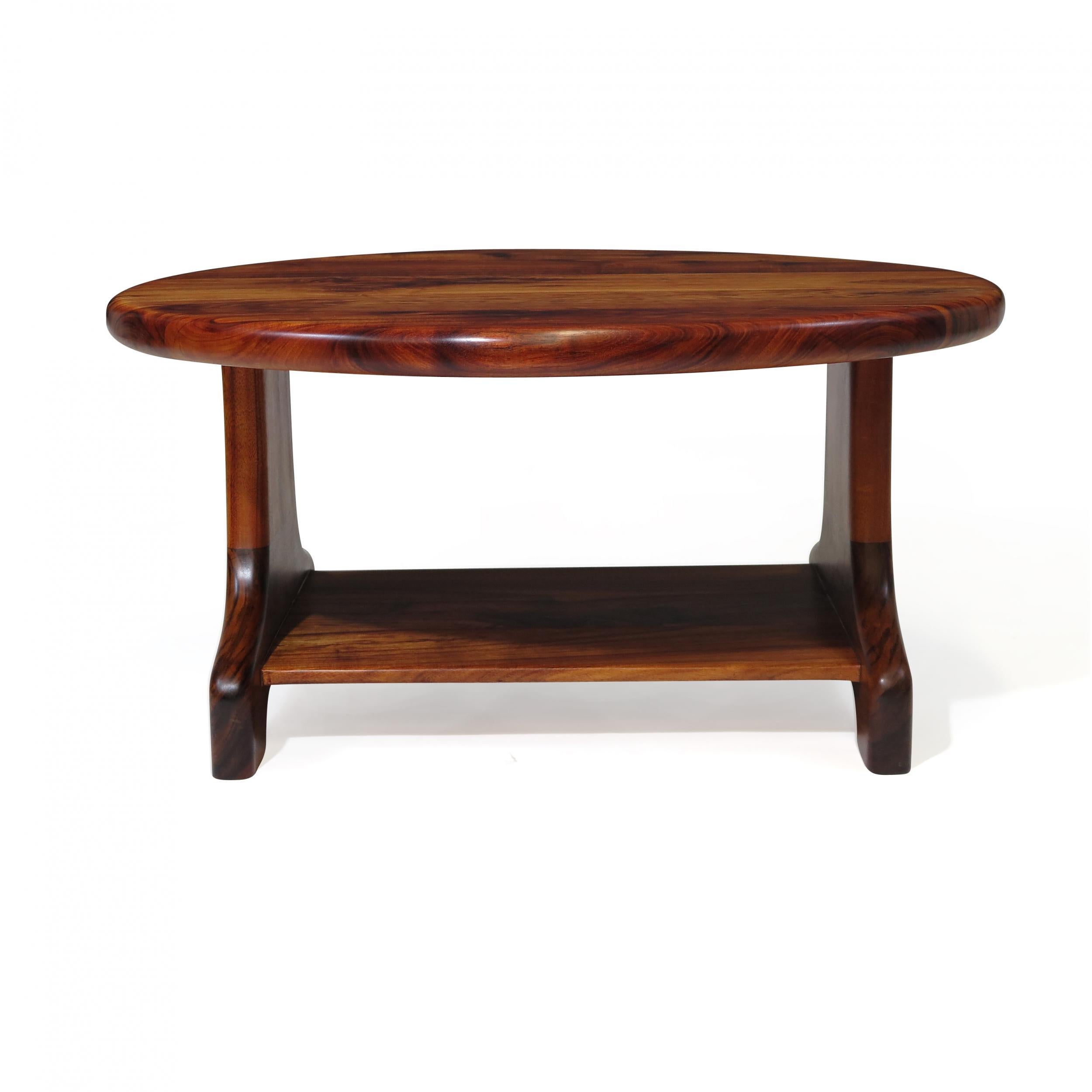 Midcentury studio crafted coffee table of solid Koa with lower shelf.
Fully restored in a natural oil to highlight the rich colors and grain of this fine wood.