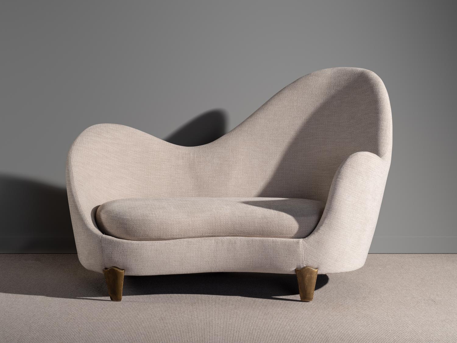 Sofa with asymmetrical arm- and backrests, upholstered in a beige, tightly woven boucle fabric. Model 