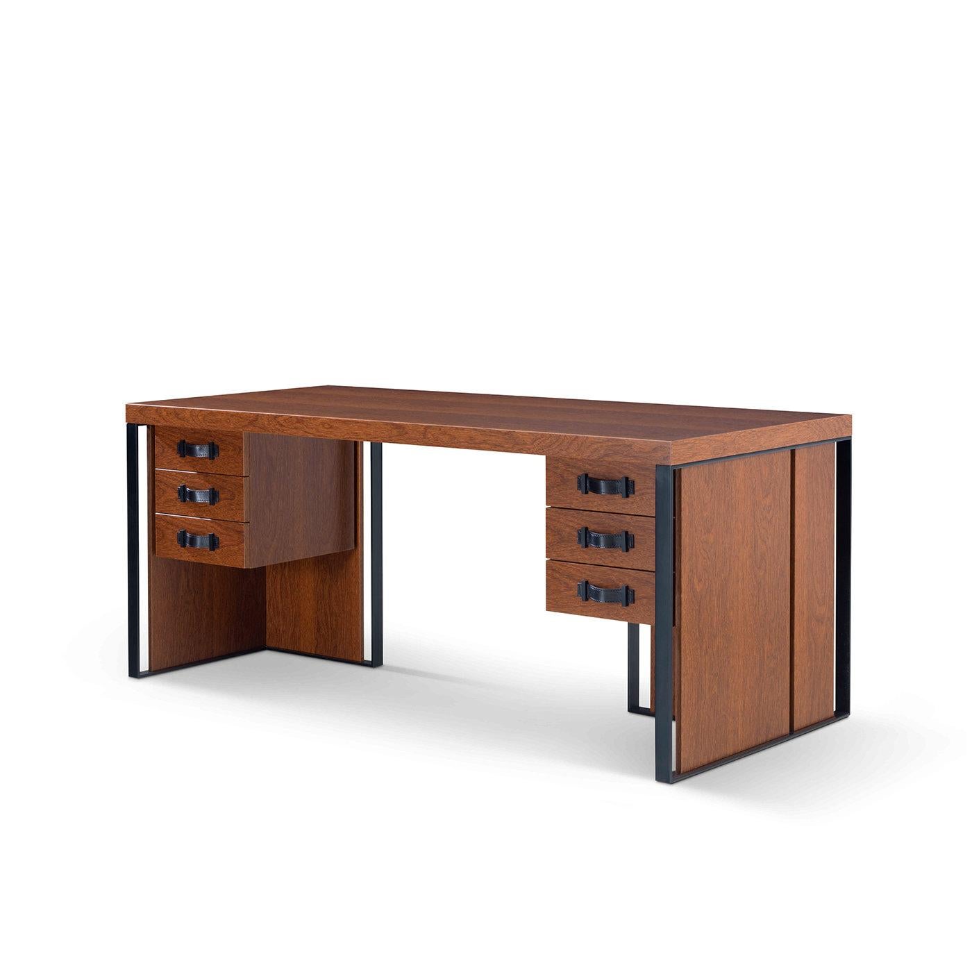 Ideal to bring impeccable, stately style into any private study, this desk merges industrial and sartorial influences. Crafted of solid, honey-hued walnut, the structure is framed by metal profiles varnished in black that outline the two angular