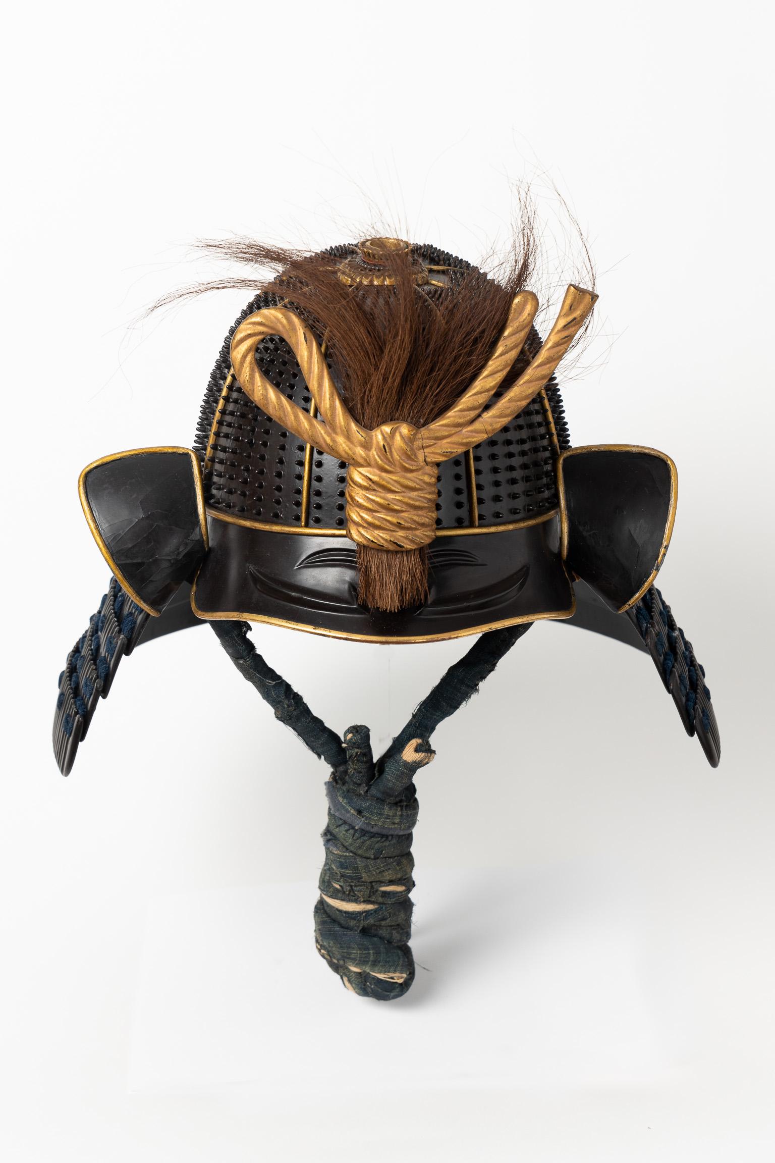 Koboshi kabuto
Samurai helmet with standing rivets
Mid Edo Period, 18th Century

Rare eight-plate kabuto with seven rows of twenty-five rivets each for a total of 1,400, which get smaller as they get closer to the peak of the helmet. The plates'