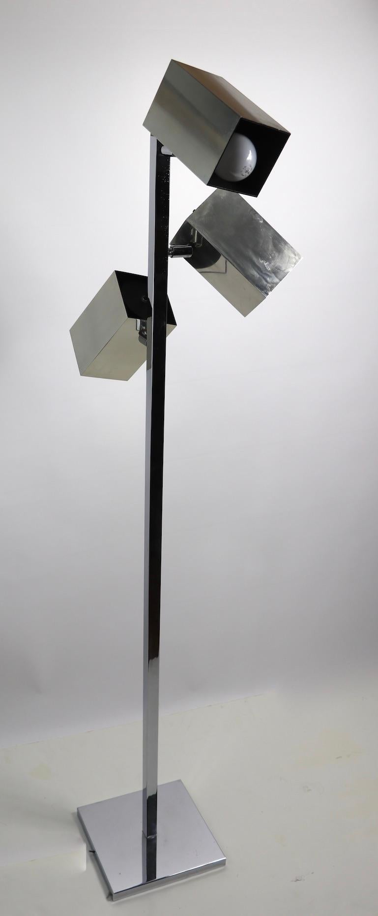 Classic 1970s Koch and Lowy chrome and aluminum three light floor lamp. This example features three independent squared form aluminum hood shades, each shade can swivel and tilt to direct and position of the light, each has its own on/off switch.