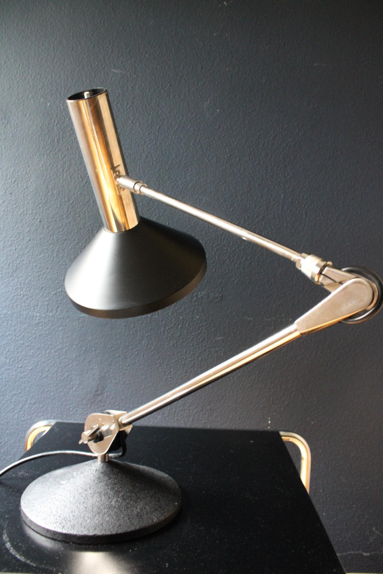 This stylish and rather big desk lamp by Koch & Lowy can be adjusted in all directions and allows to be turned 360 degrees at the base.

Despite its age of 60+ years this lamp is in very good condition and an E27 bulb makes it ideal for task