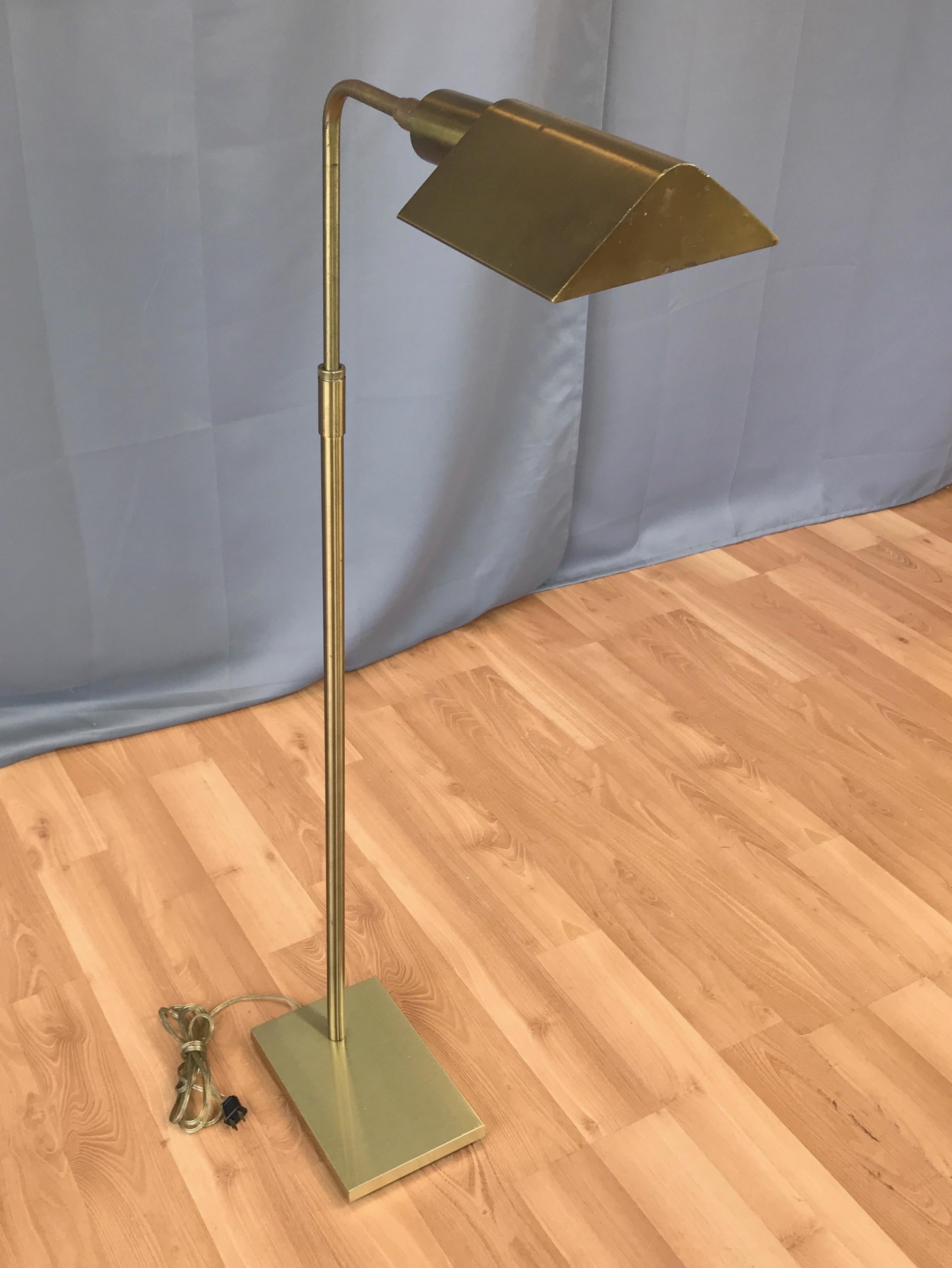 A 1960s pharmacy-style brass floor lamp by Koch & Lowy.

Adjustable height articulated and rotatable shade makes this timeless classic an ideal chair-side reading lamp. Shade and neck have a less common slightly muted, faintly brushed finish.