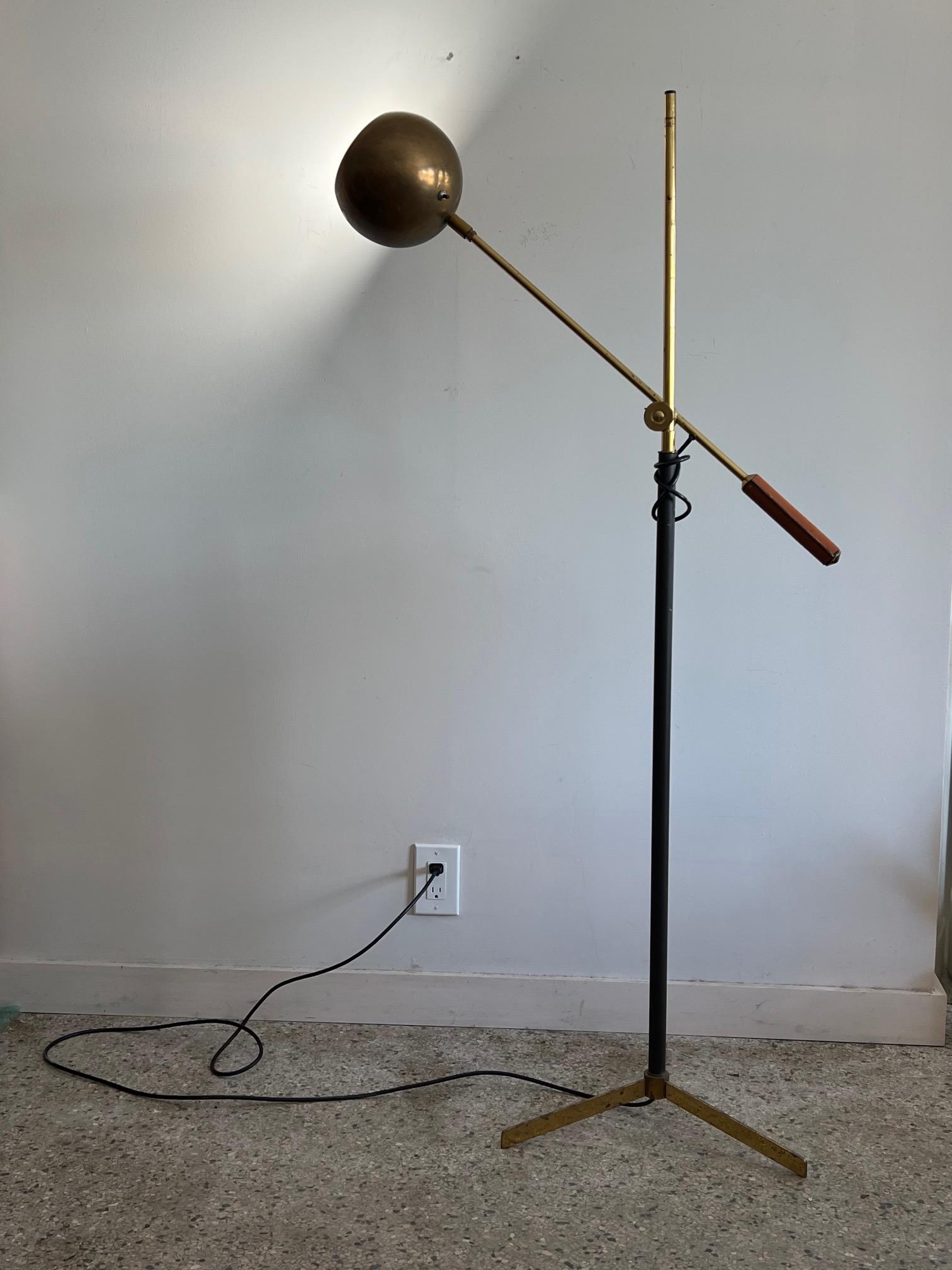 A Classic articulating reading or task lamp manufactured by Koch & Lowy, in the style of Arteluce or Arredoluce. Leather covered handle, brass shade and pole. Nicely detailed.