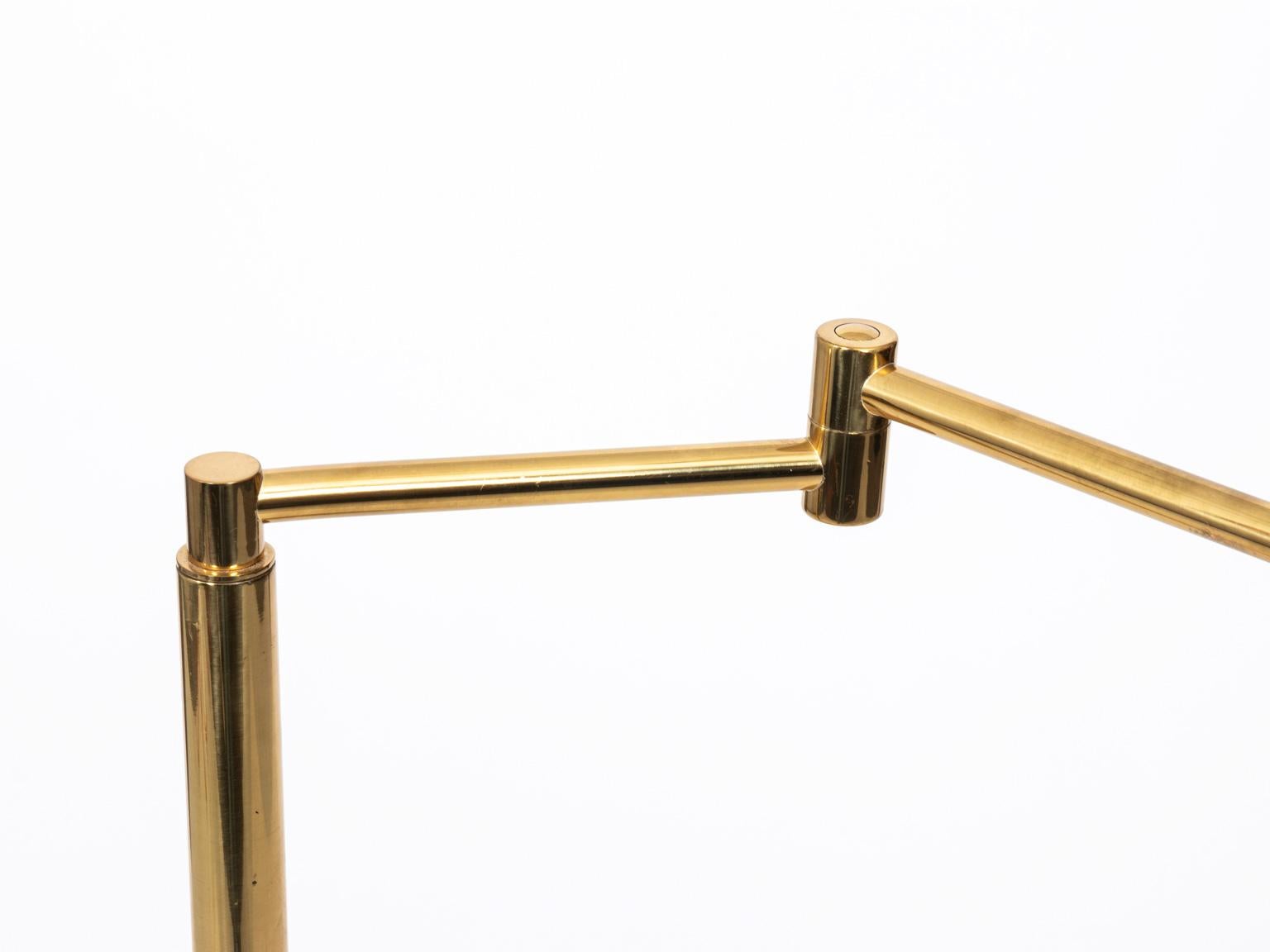 Brass floor lamp by Koch & Lowy with original patina and maker's mark, circa 1960s. The lamp features adjustable height and DIM-able lights. Please note of minor scratches due to wear with age. Made in the United States.