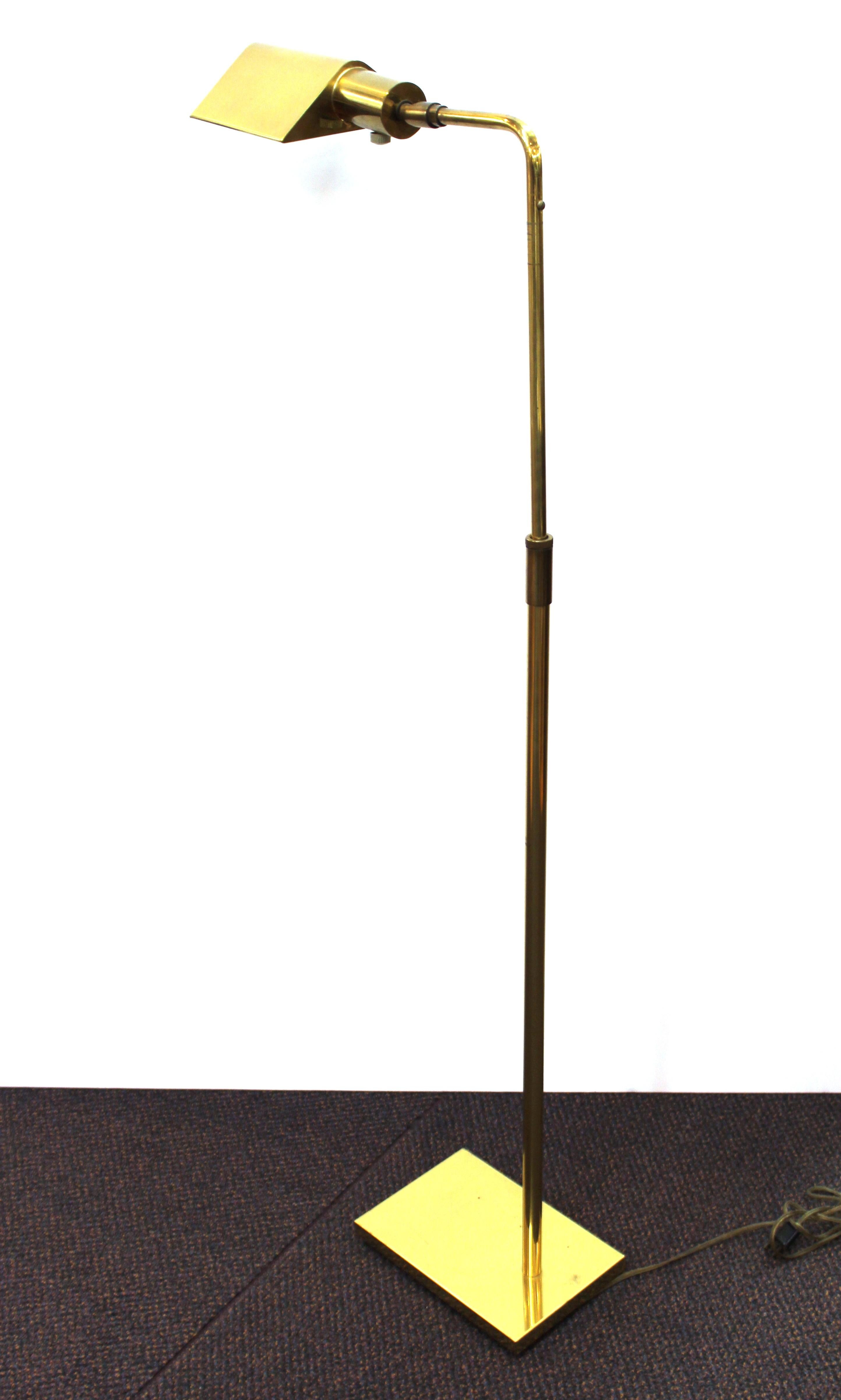 Mid-Century Modern adjustable pharmacy floor lamp in brass, made by Koch & Lowy in the United States during the 1960s. The piece is in great vintage condition with some minor age-appropriate wear. Stamped on the upper neck 'Koch & Lowy'.