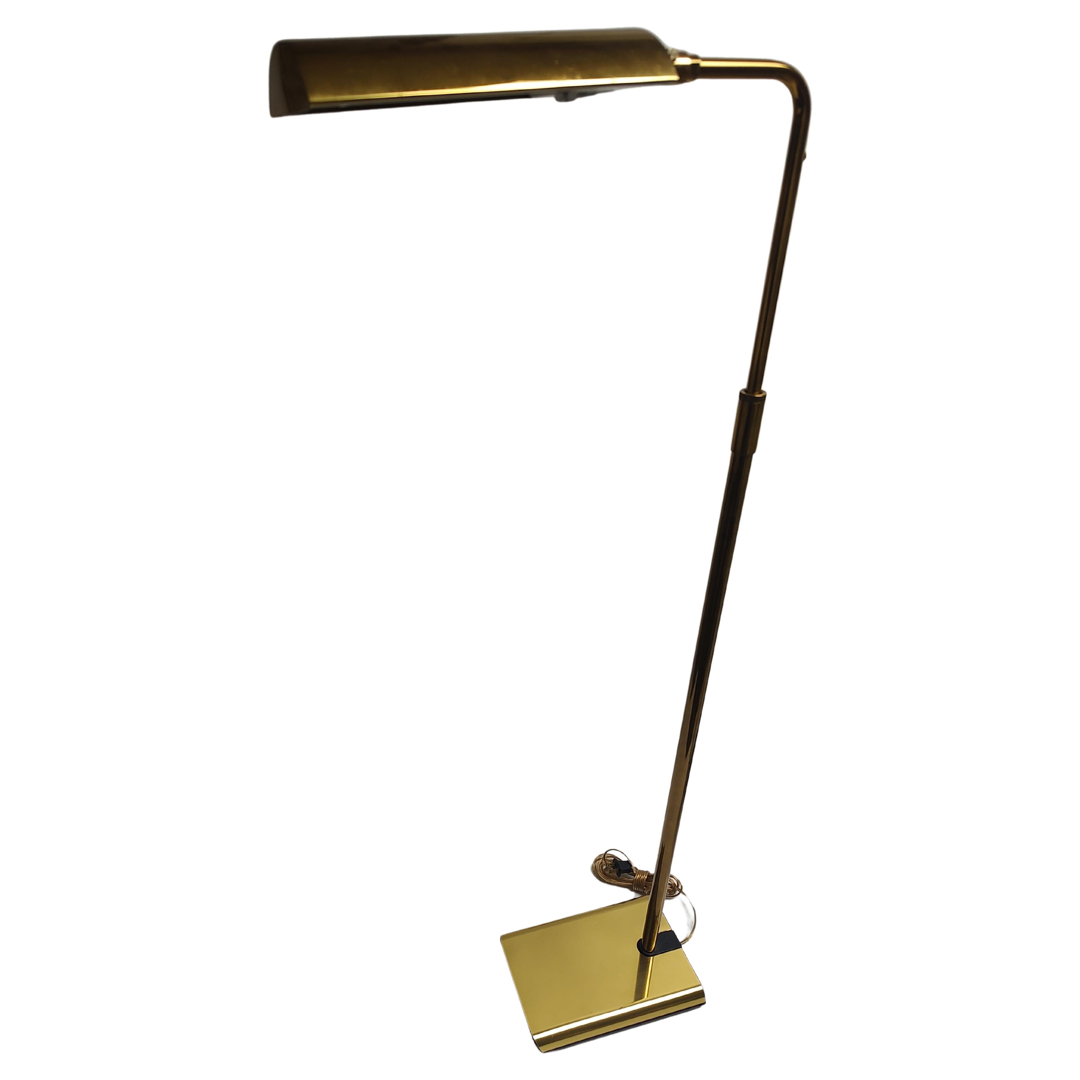 Simple and elegant brass reading pharmacy lamp by Koch & Lowy c1975. In excellent vintage condition with minimal wear. Totally adjustable in height from 41.5 to 47.5 and flexing tilting shade can be positioned to your needs. Weighted base which is