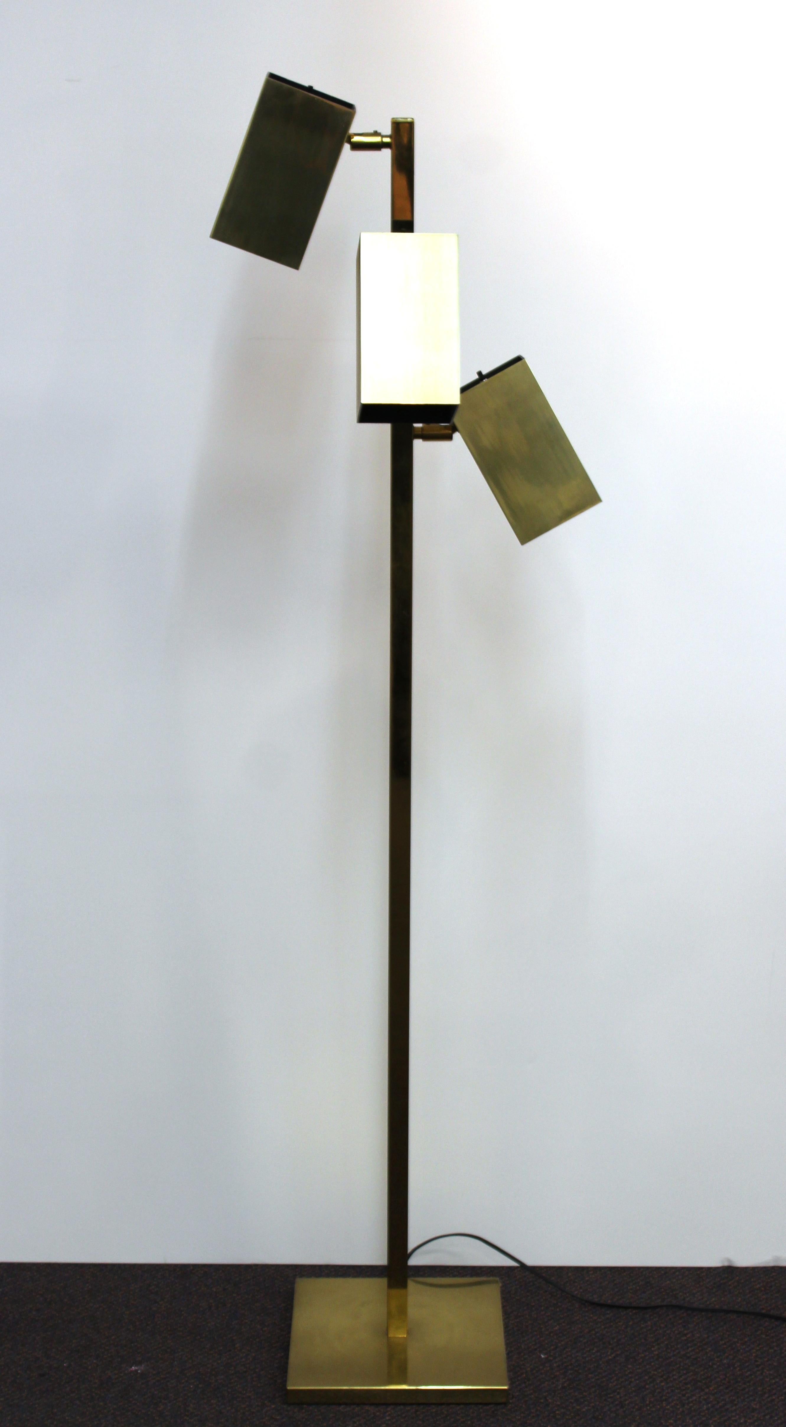 Koch & Lowy modernist floor lamp in brass, with three pivoting shades. The piece is in good vintage condition with some age-appropriate wear to the stem and shades.