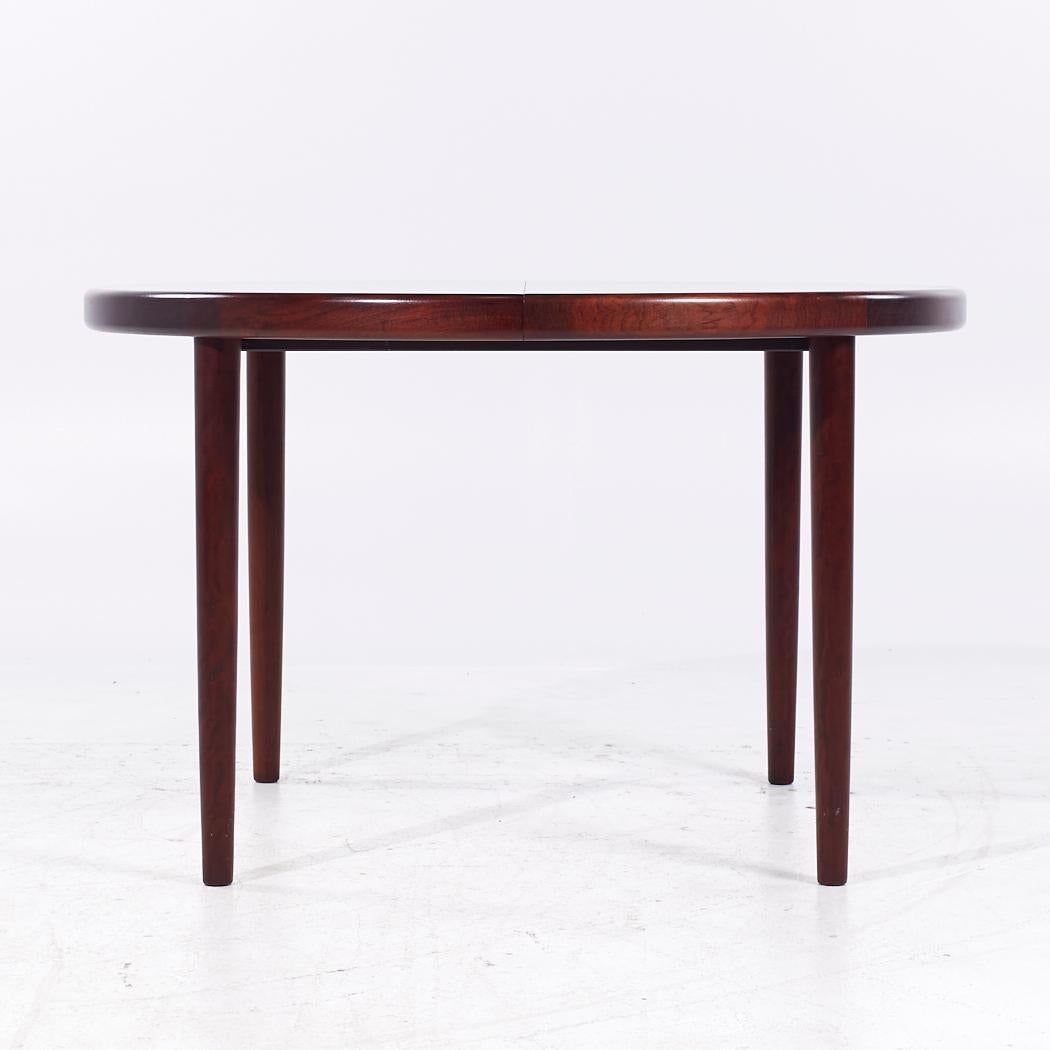 Kofod Larsen for Faarup Mobelfabrik Mid Century Danish Rosewood Expanding Dining Table with 2 Leaves

This table measures: 46.5 wide x 46.5 deep x 29 inches high, with a chair clearance of 26.75 inches, each leaf measures 19.75 inches wide, making a