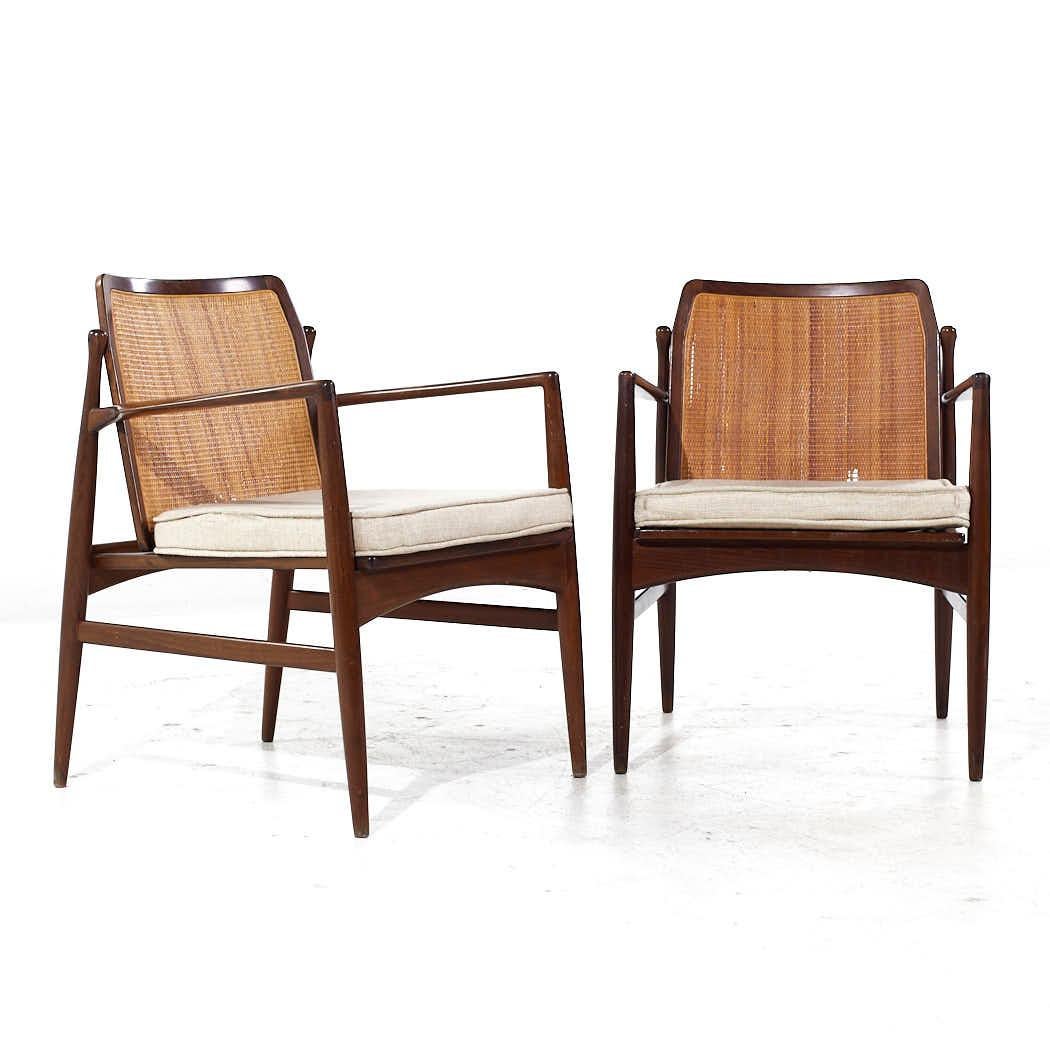 Kofod Larsen for Selig Mid Century Walnut and Cane Lounge Chairs - Pair

Each lounge chair measures: 23.5 wide x 25 deep x 30 high, with a seat height of 17.5 and arm height/chair clearance 24.25 inches

All pieces of furniture can be had in what we