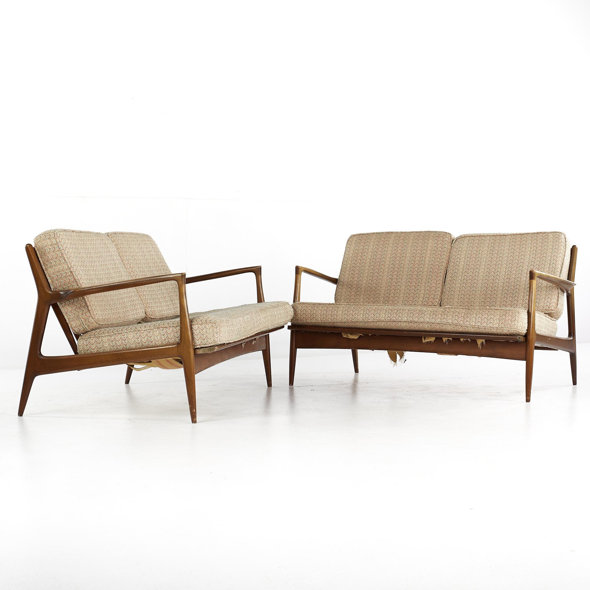 Kofod Larsen for Selig mid-century walnut settee - pair.

Each settee measures: 53 wide x 32 deep x 29 inches high, with a seat height of 16 and arm height of 22.75 inches

All pieces of furniture can be had in what we call restored vintage