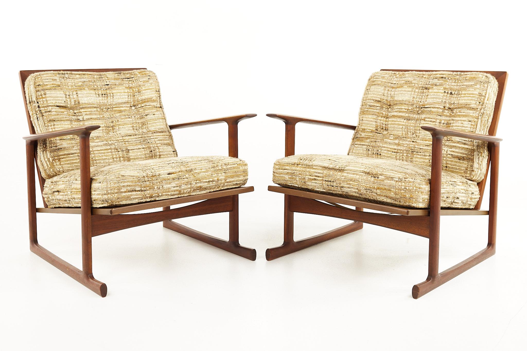 Kofod Larsen for Selig Mid Century Teak Sleigh Leg Lounge Chairs - A Pair

Each chair measures: 29 wide x 31 deep x 28 high, with a seat height of 16 inches and arm height of 22 inches

All pieces of furniture can be had in what we call restored