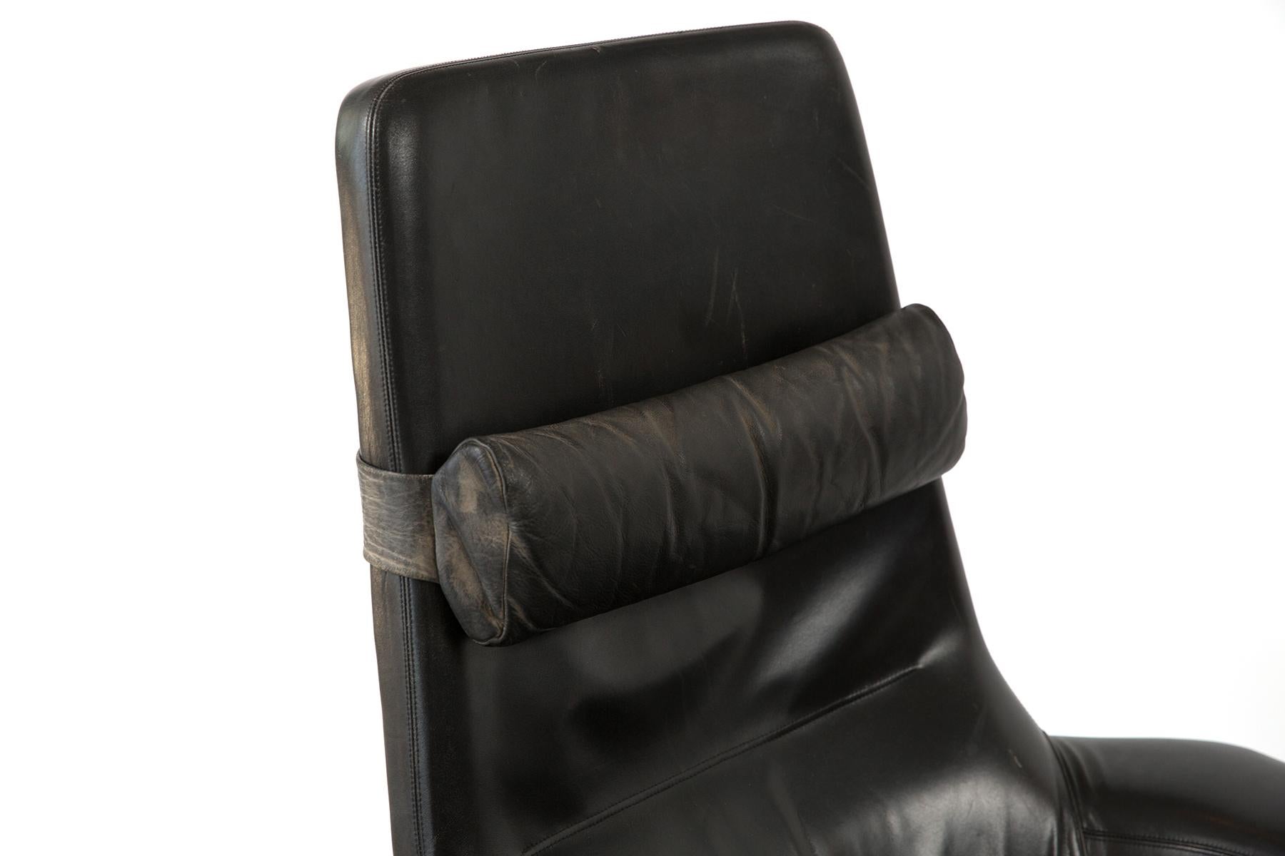 This handsome Kofod Larsen black leather lounger is complete with matching ottoman and headrest cushion. The set currently sports original leather with all of its well-loved appeal. Let Red Modern assist you with any reupholstery choices, or keep it
