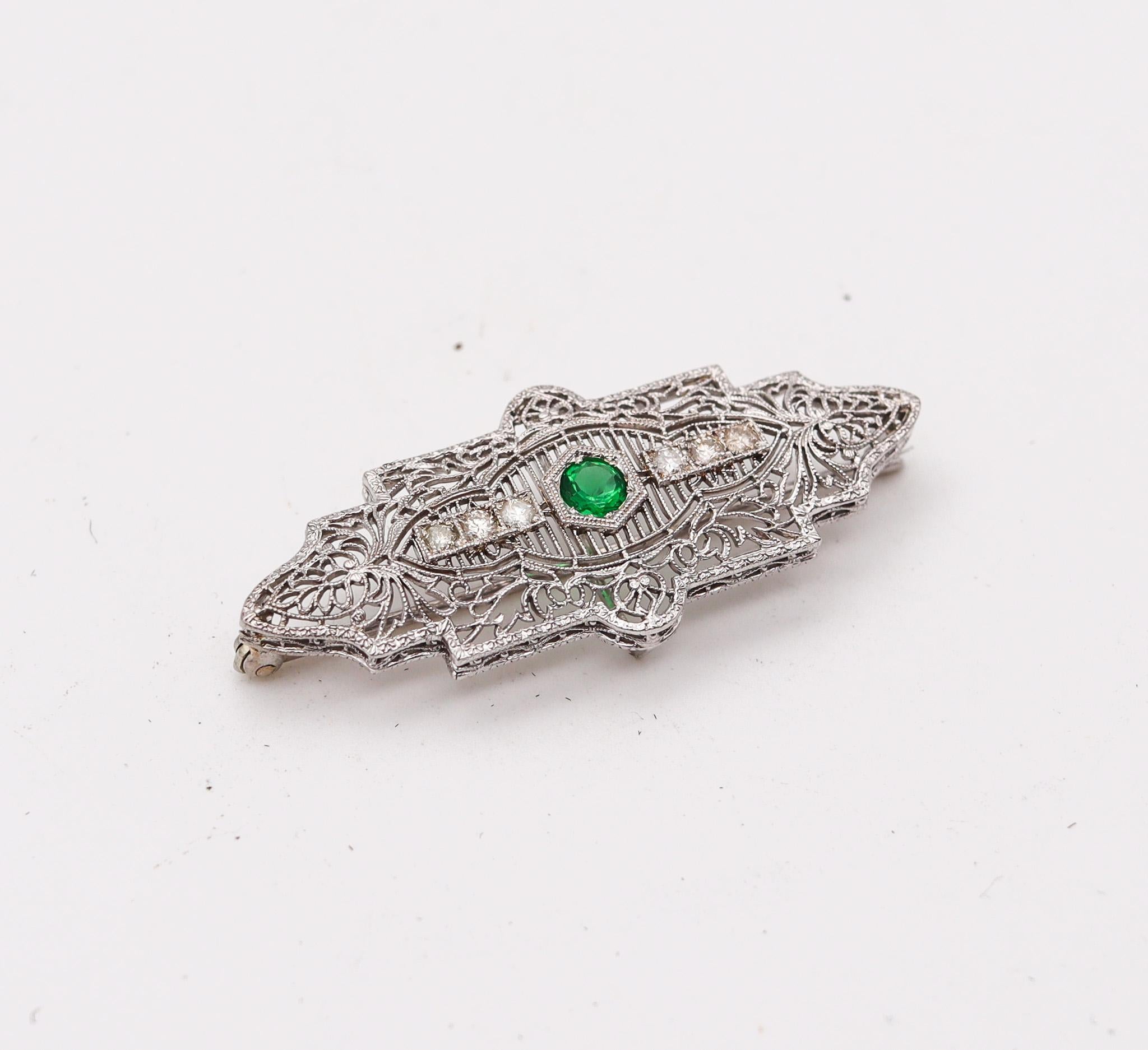 An art deco geometric brooch.

Delicate art deco brooch-pendant, created in Newark United States by the Kohn & Co Inc. back in the 1925. This beautiful piece was crafted in white gold of 14 karats and mount with a great selection of gemstones, The