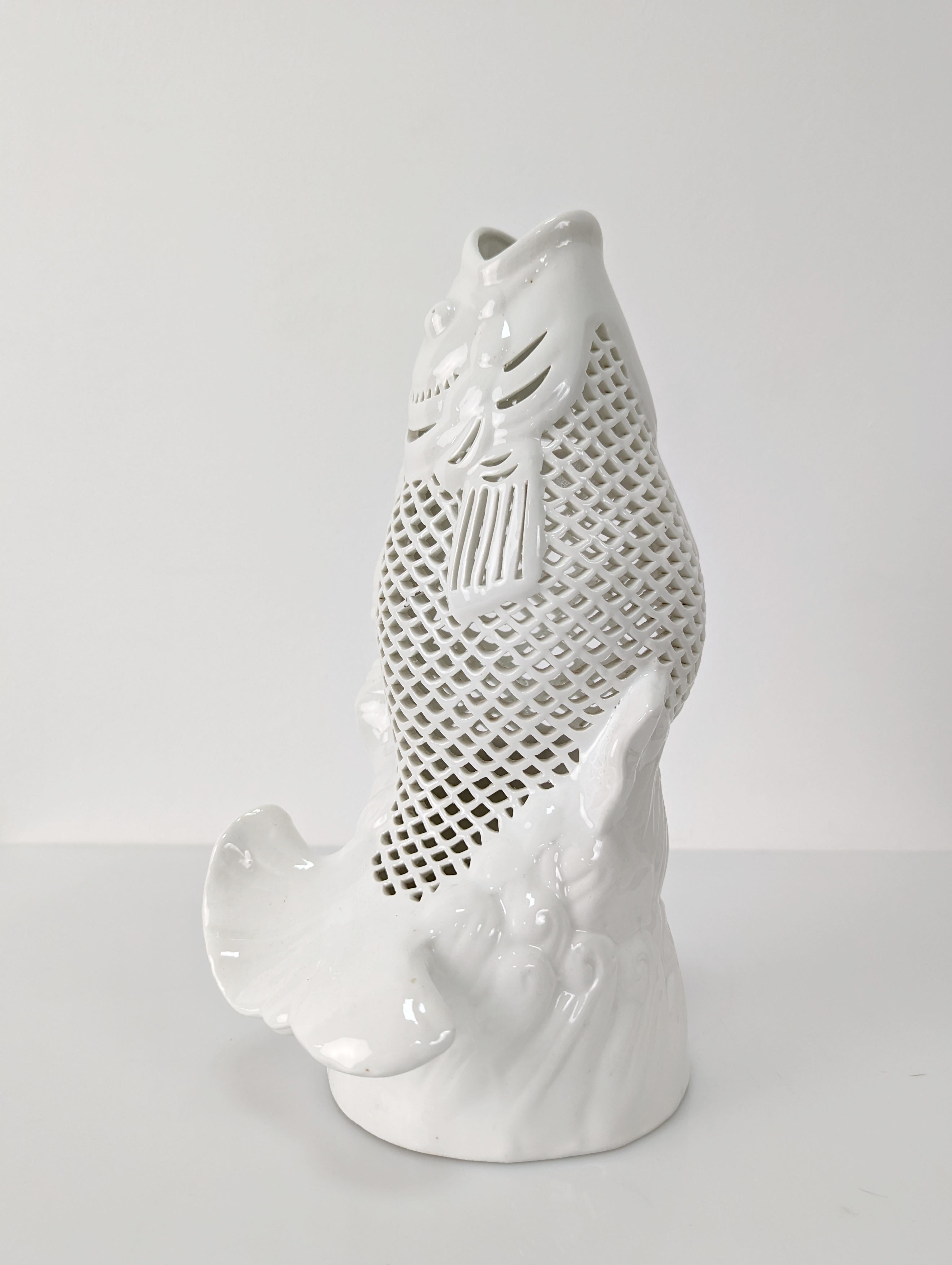 Beautiful sculpture representing a carp jumping over the water, made of white reticulated porcelain from China, specifically this type of piece can be found in areas of Hong Kong in the mid-20th century.