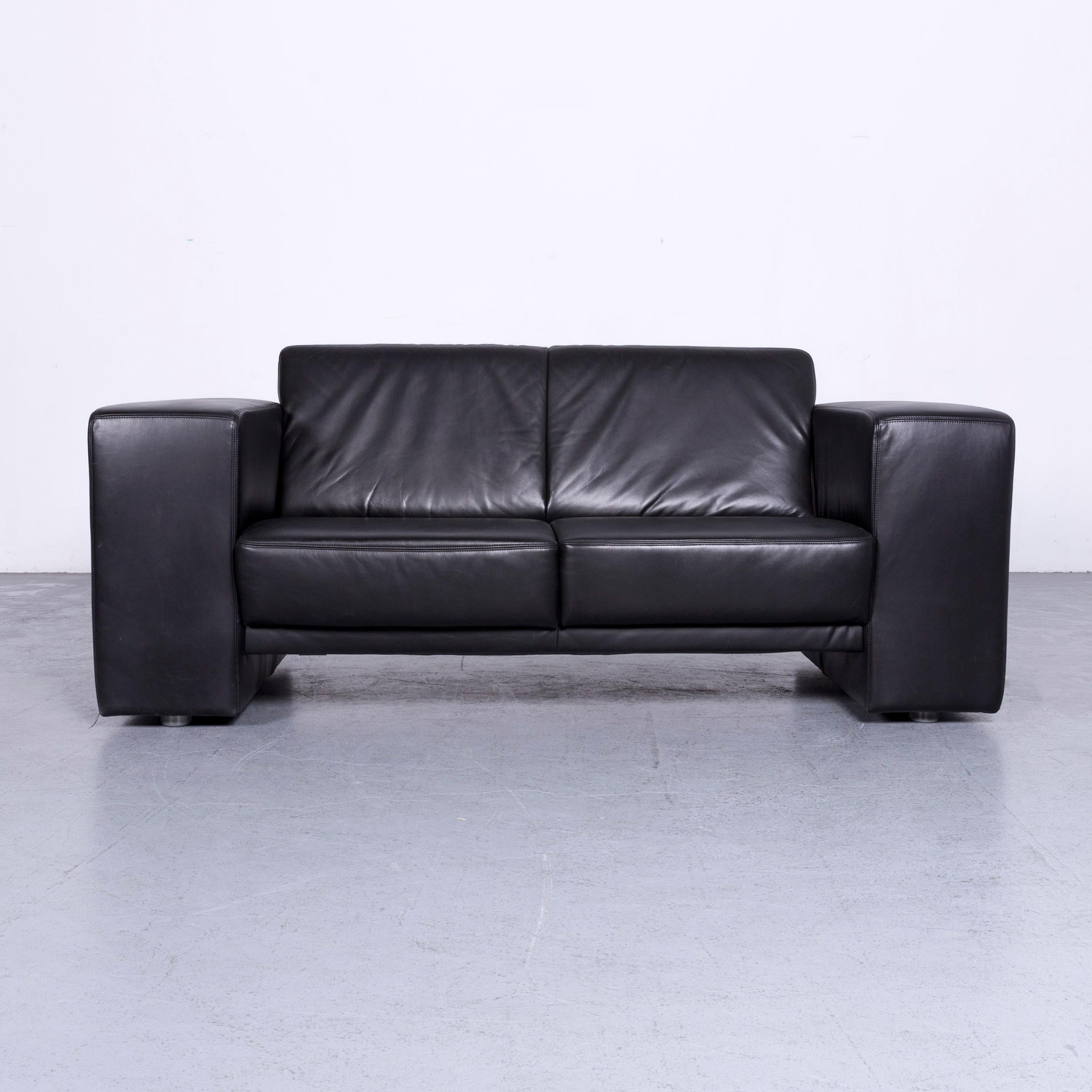 We bring to you a Koinor Rossini designer leather sofa black two-seat couch.