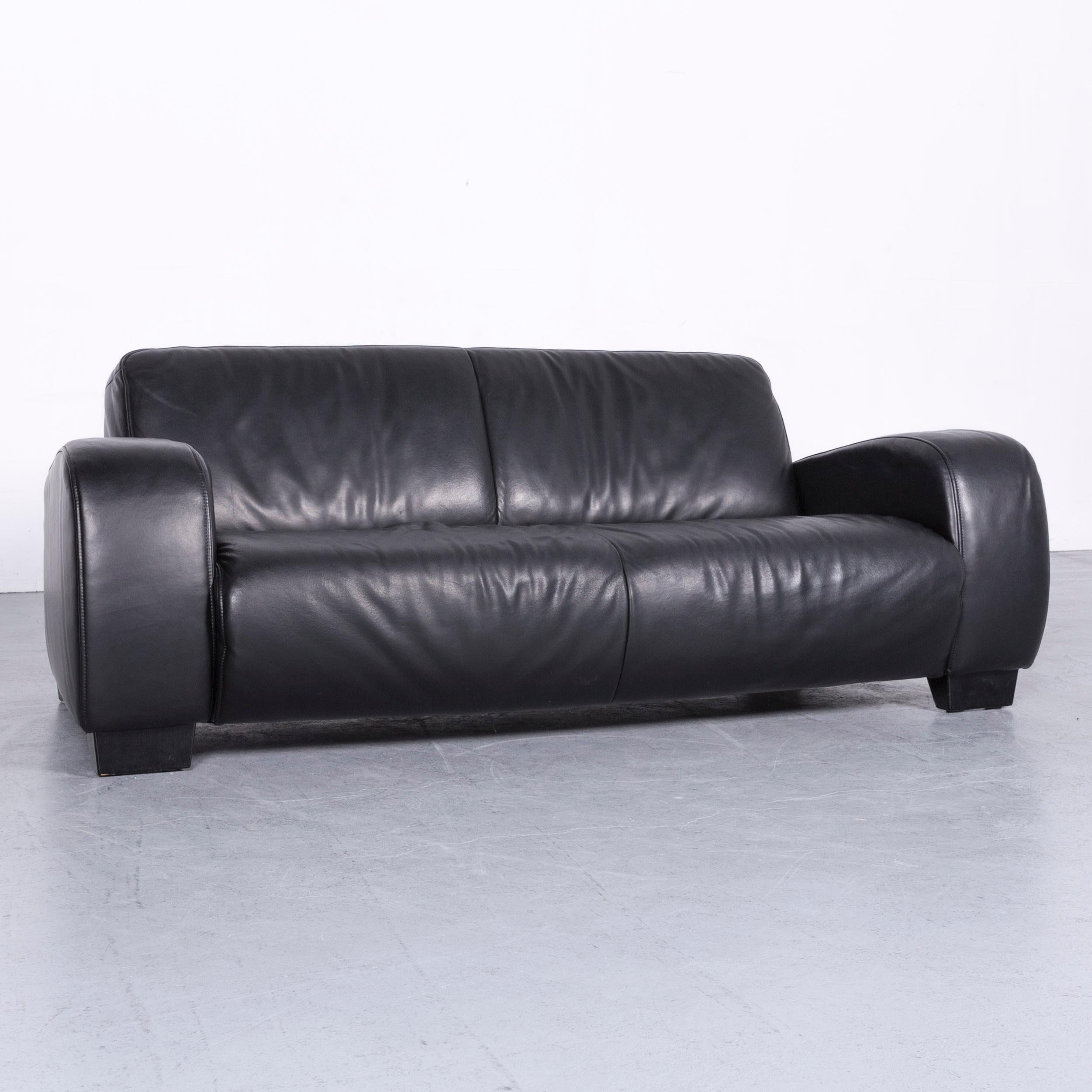 We bring to you a Koinor Rossini designer leather sofa black two-seat couch.