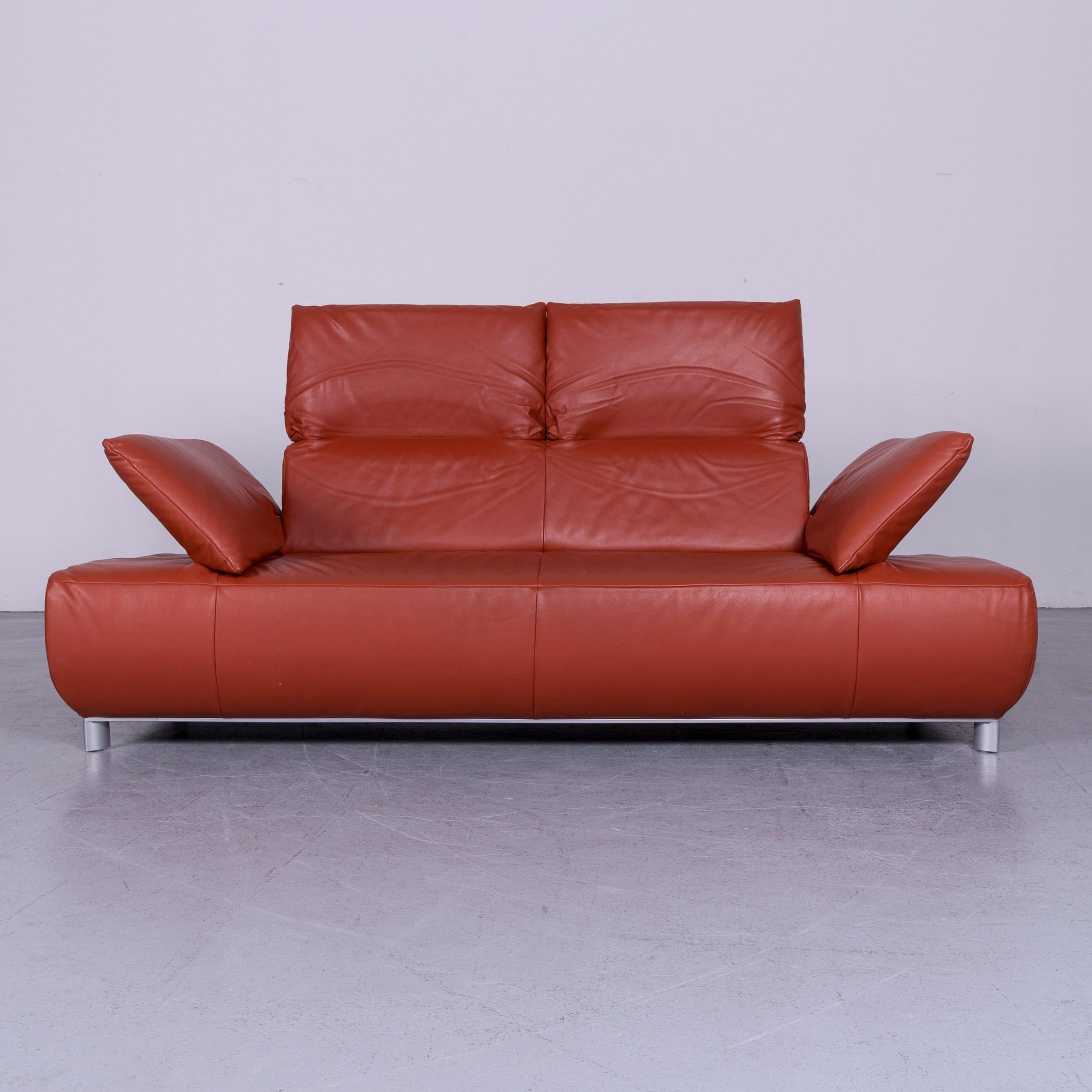 We bring to you an Koinor Volare designer leather sofa red three-seat couch with function.