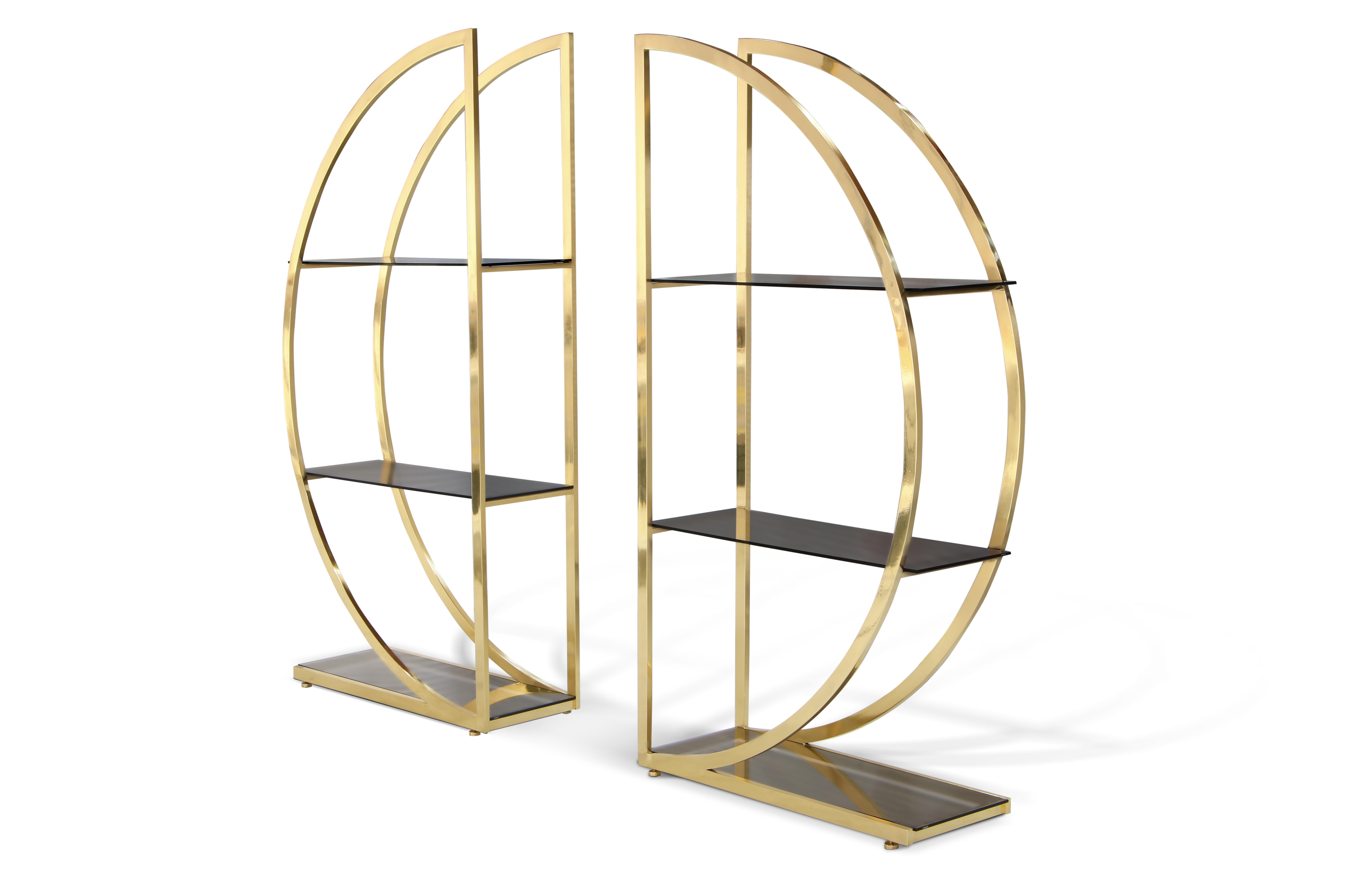 Decadence is a Bookcase with two ornate metal semi-circles joined in a glamorous union by sleek glass shelves and her backless design allows for the perfect canvas to store your simple pleasures.

Structure: Polish Brass 
Shelves: Bronze